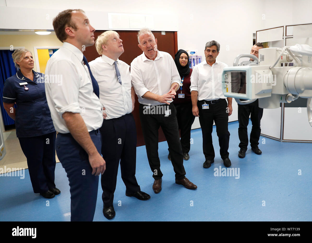 Prime Minister Boris Johnson (3rd left) and Matt Hancock, Secretary of State for Health and Social Care (2nd left) during a visit to Pilgrim Hospital in Boston, Lincolnshire, to announce the government's NHS spending pledge of 1.8 billion. Stock Photo