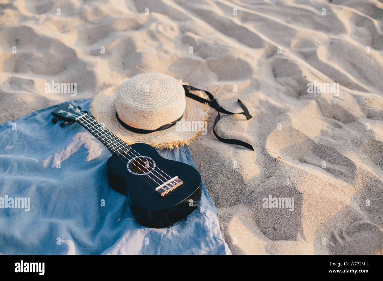 Still life with straw hat and ukulele on the beach. Summer concept Stock  Photo - Alamy