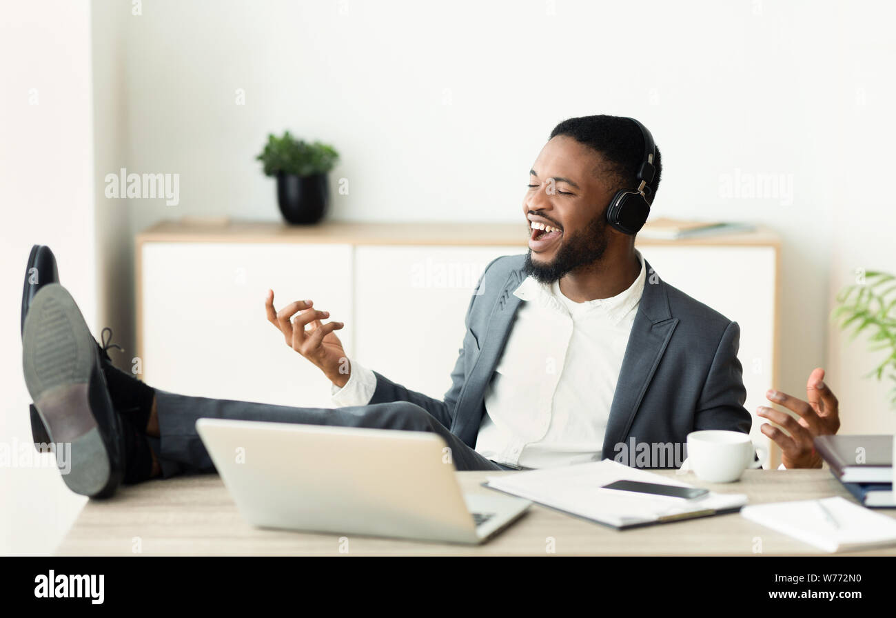 African businessman imagining that he is a rockstar Stock Photo