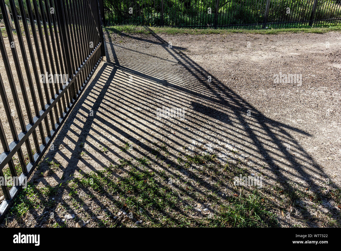 A portion of the border fence along the edge of Laredo Community College's campus in Laredo, Texas Stock Photo