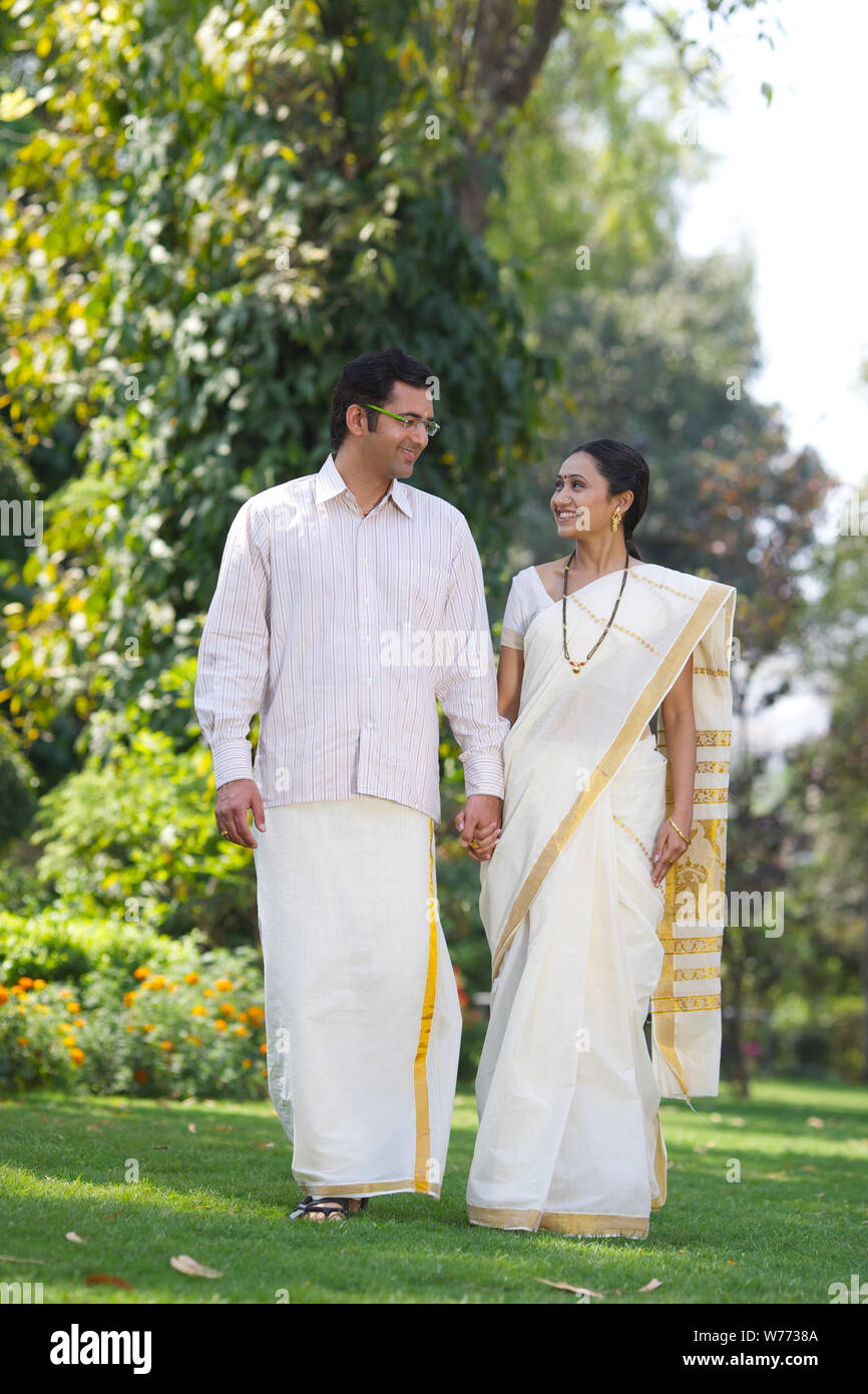 South Indian couple walking in a park Stock Photo - Alamy