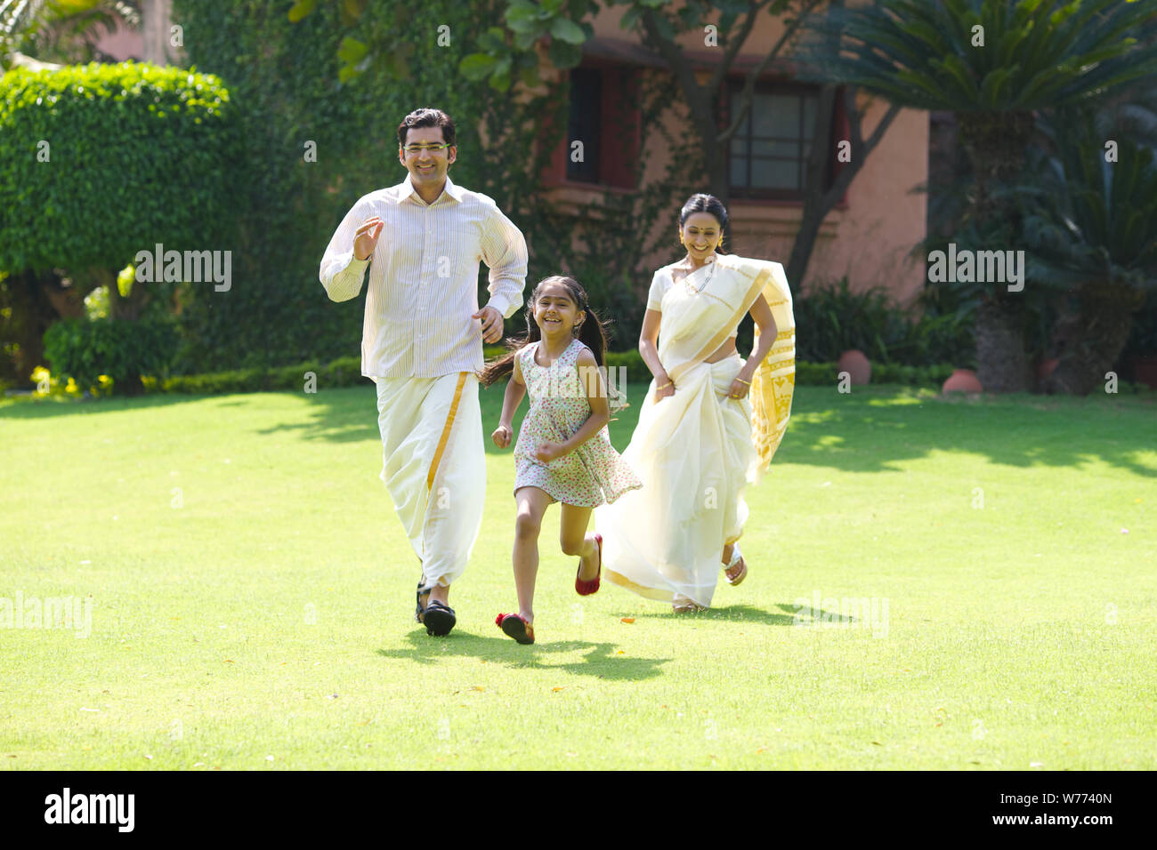 South Indian family playing in a lawn Stock Photo - Alamy