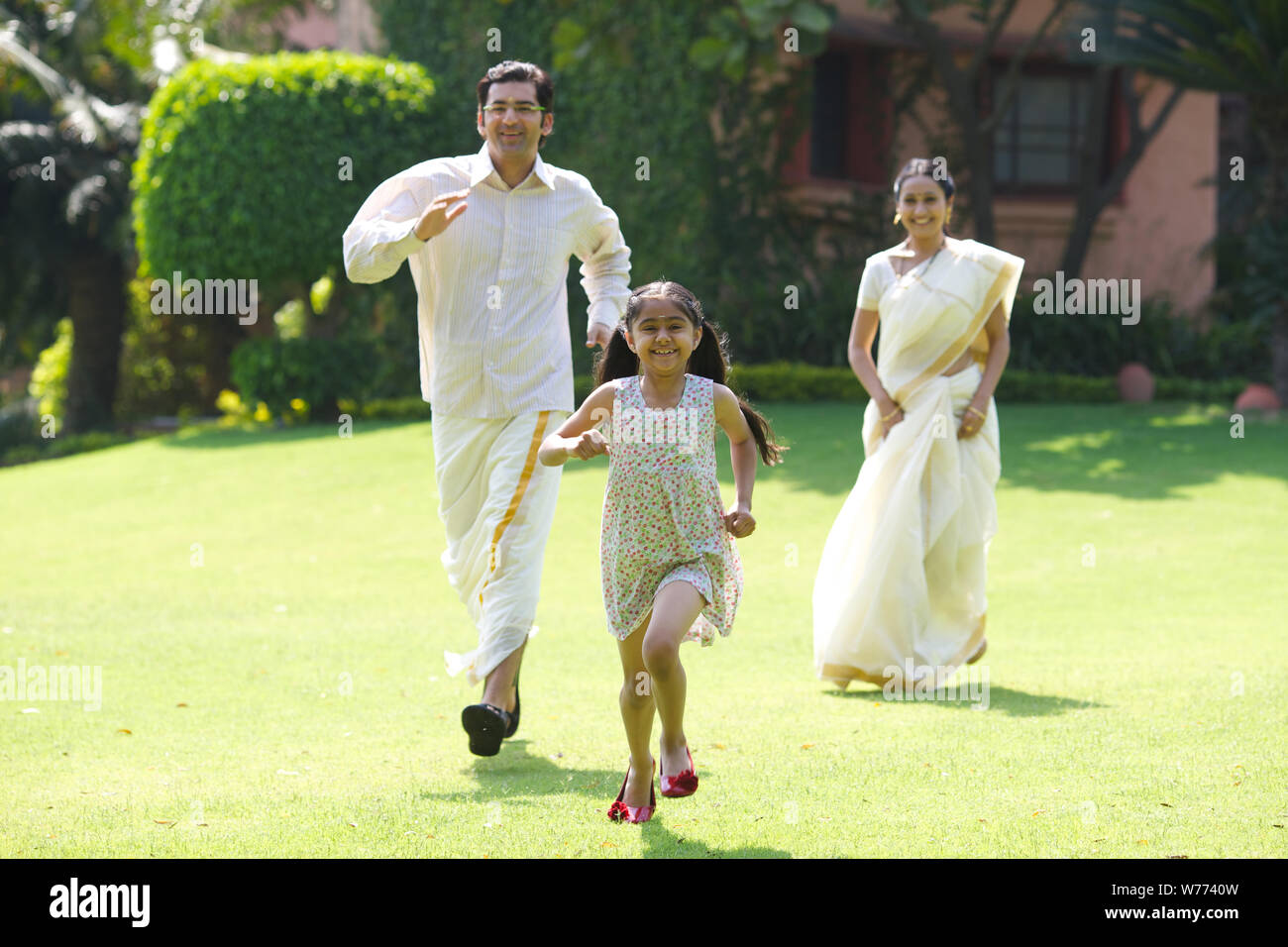 South Indian family playing in a lawn Stock Photo - Alamy