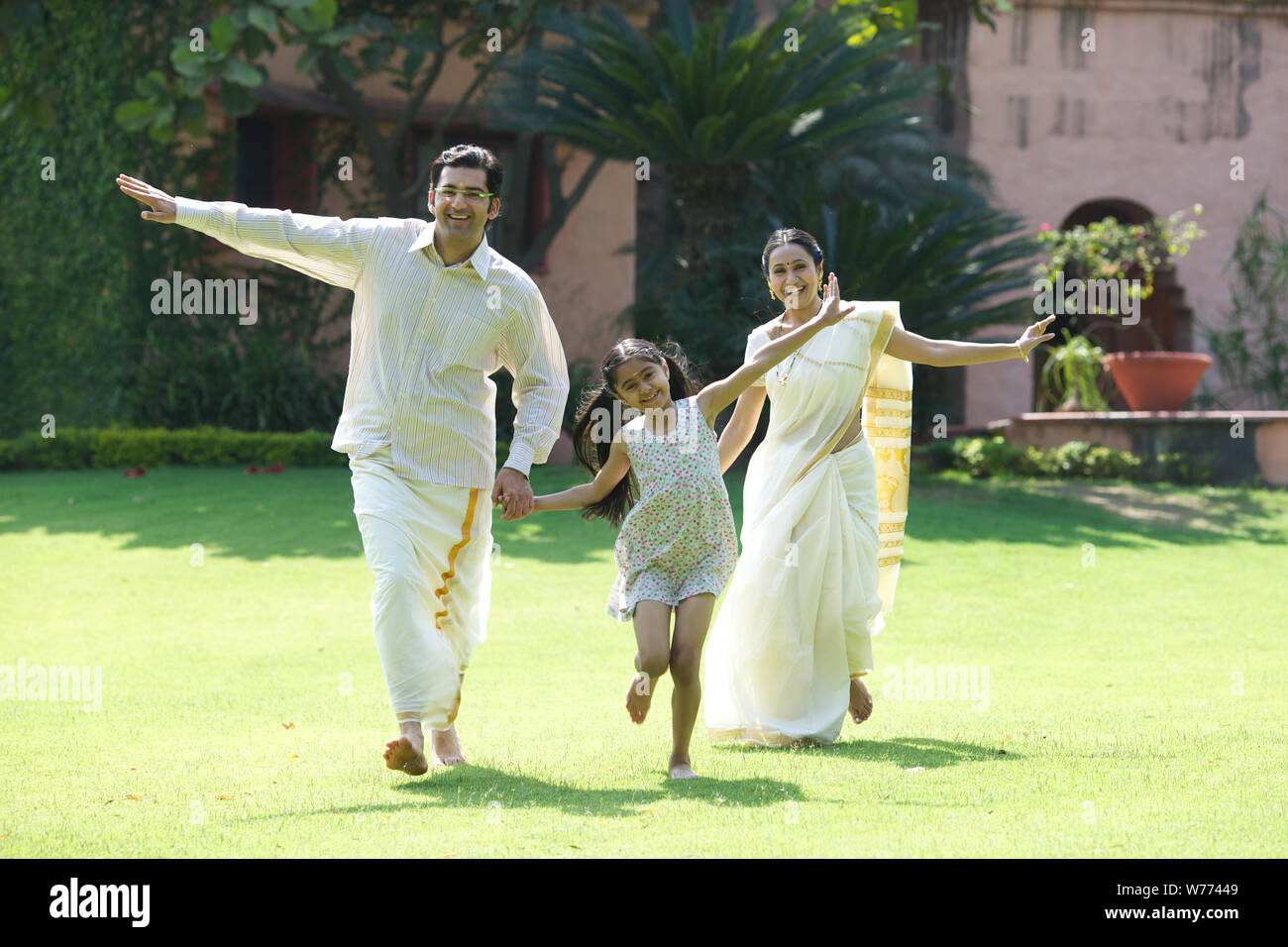 South Indian family playing in a lawn Stock Photo - Alamy