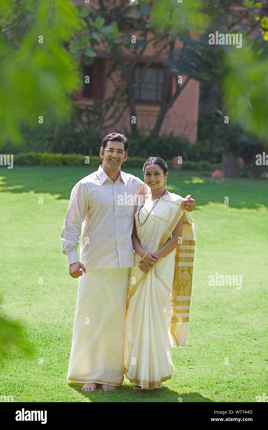 South Indian couple standing together in a lawn Stock Photo - Alamy