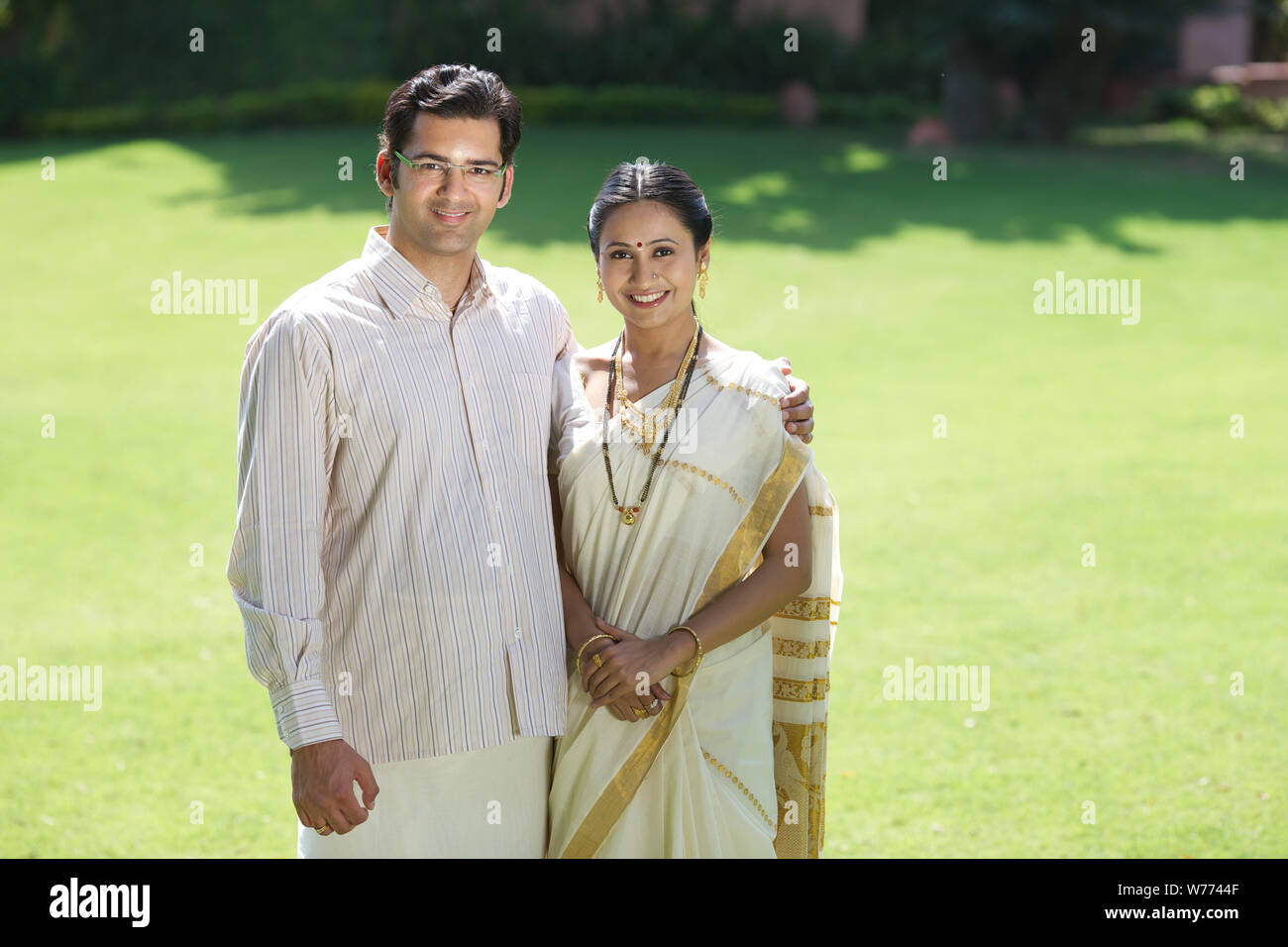 South Indian couple standing together in a lawn Stock Photo - Alamy