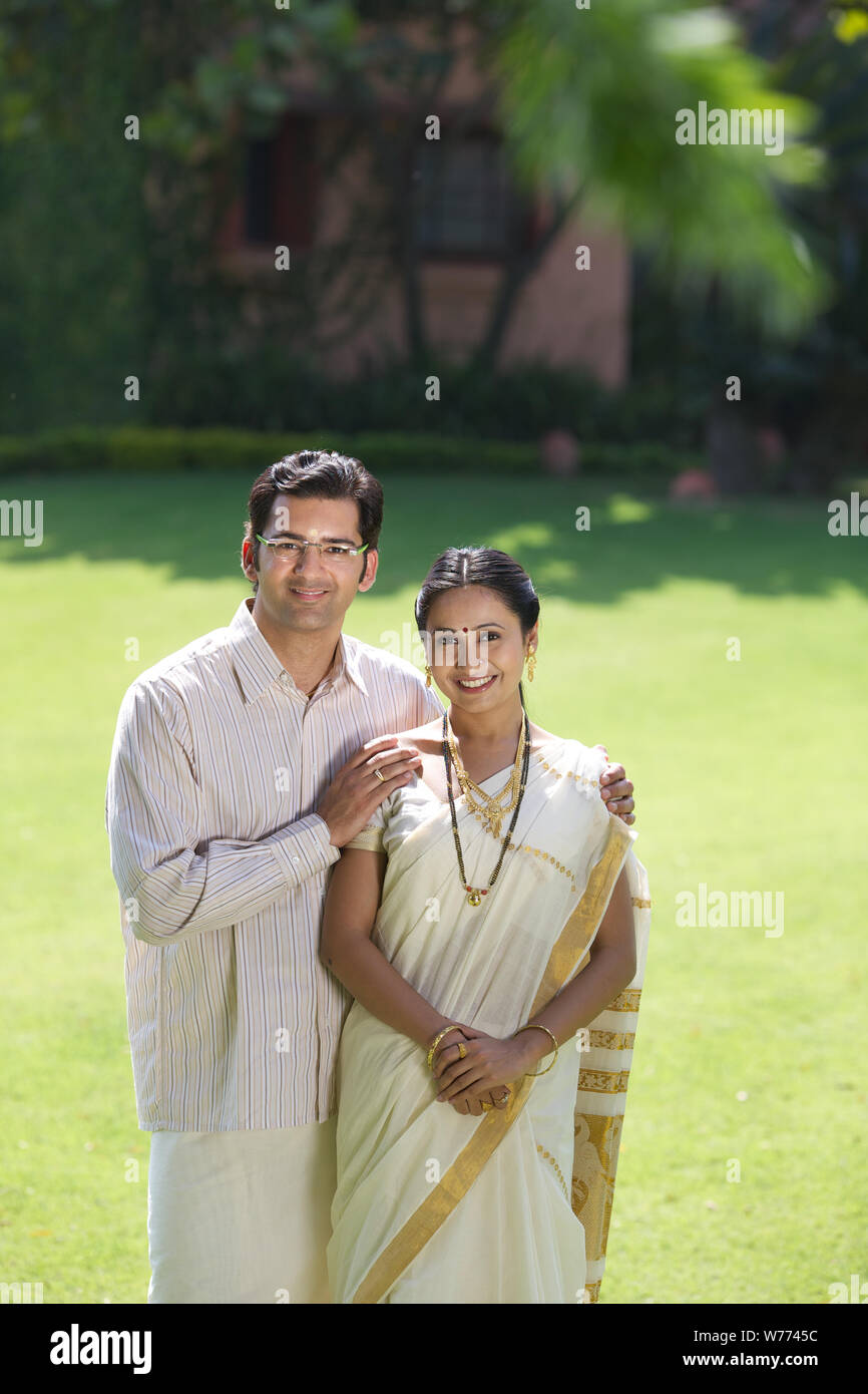 South Indian couple standing together in a lawn Stock Photo - Alamy