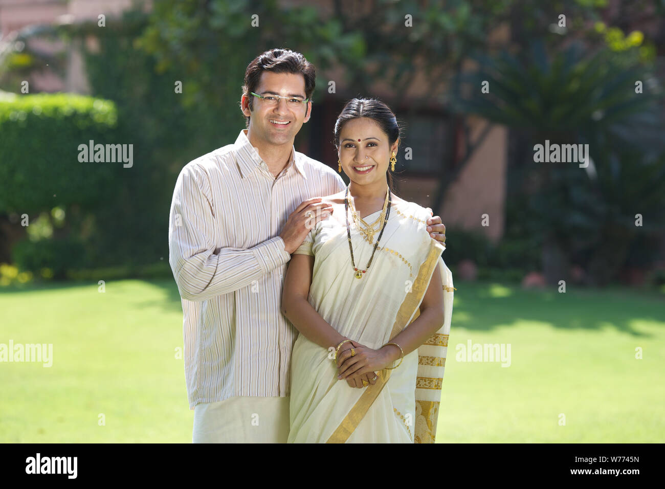 South Indian couple standing together in a lawn Stock Photo - Alamy