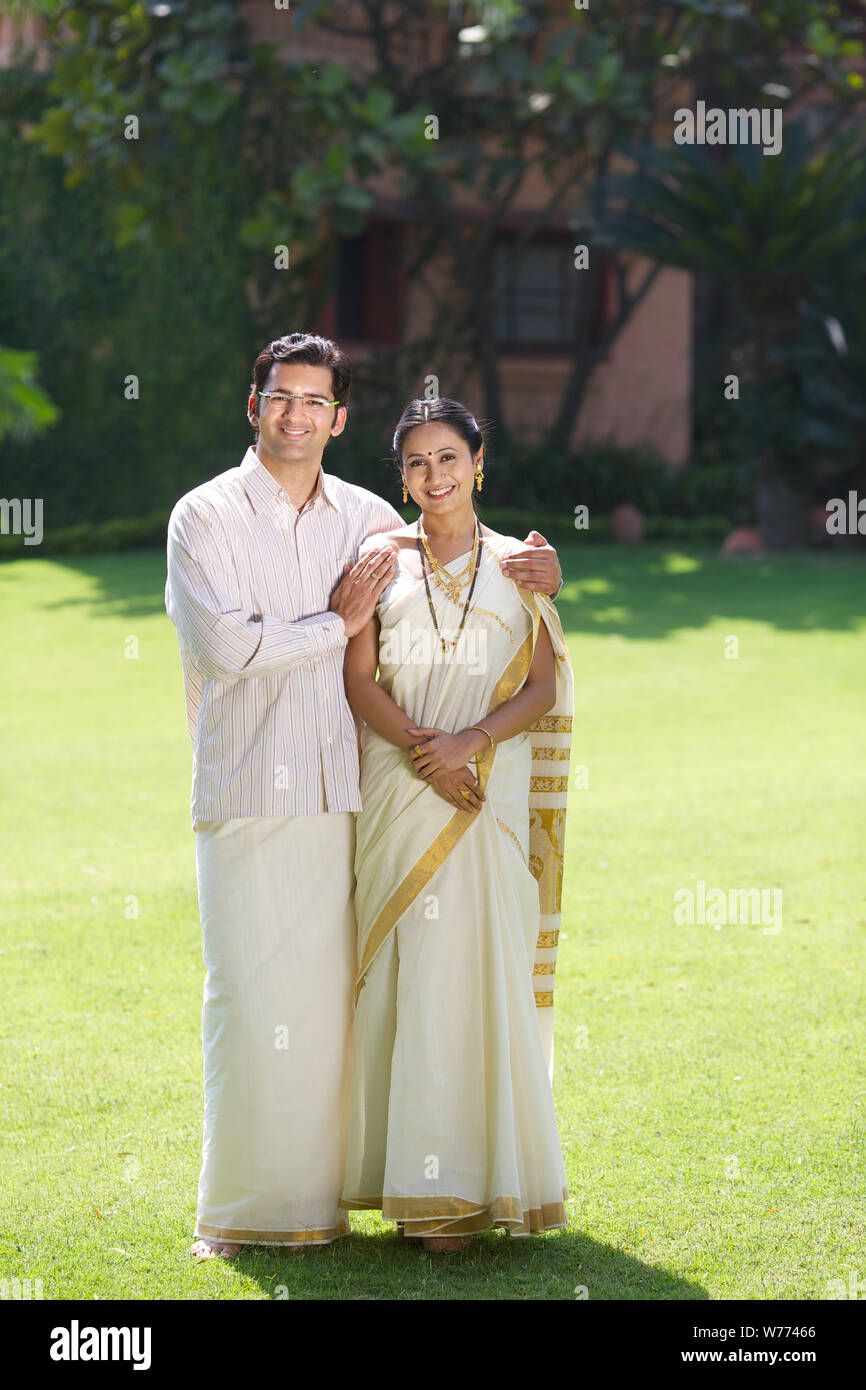 South Indian couple standing together in a lawn Stock Photo - Alamy