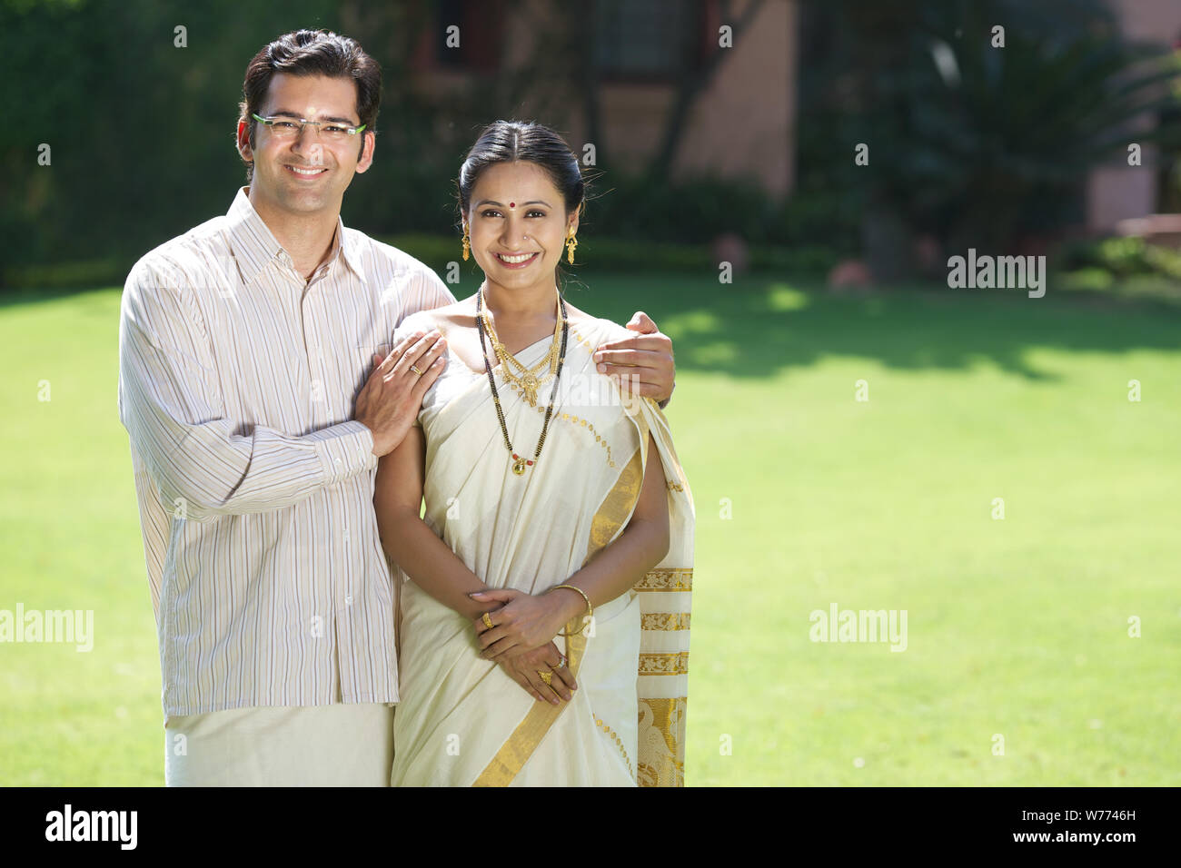 South Indian couple standing together in a lawn Stock Photo - Alamy