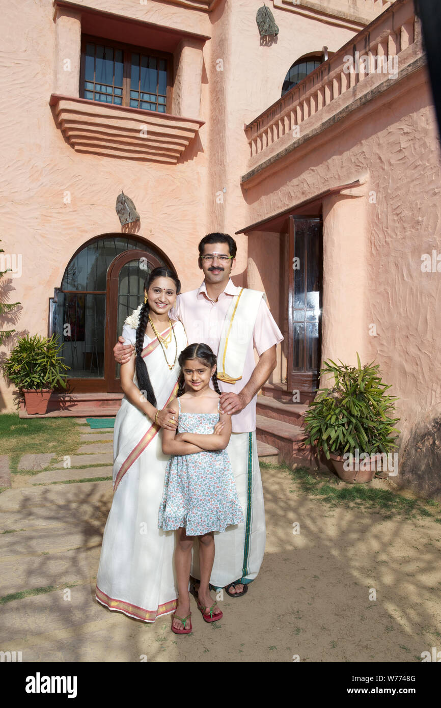 South Indian family standing together in front of house Stock Photo - Alamy