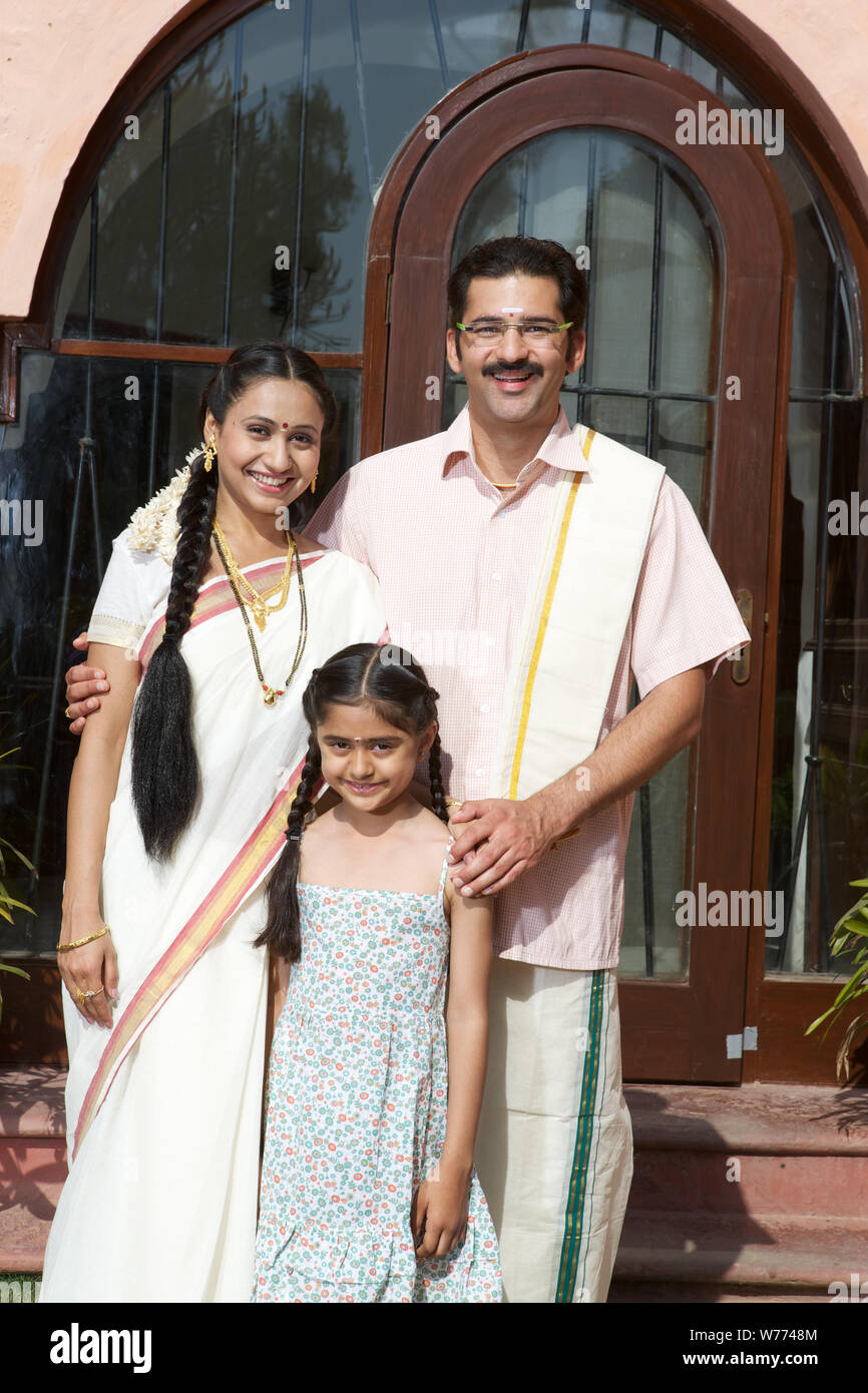 South Indian family standing together in front of house Stock Photo - Alamy