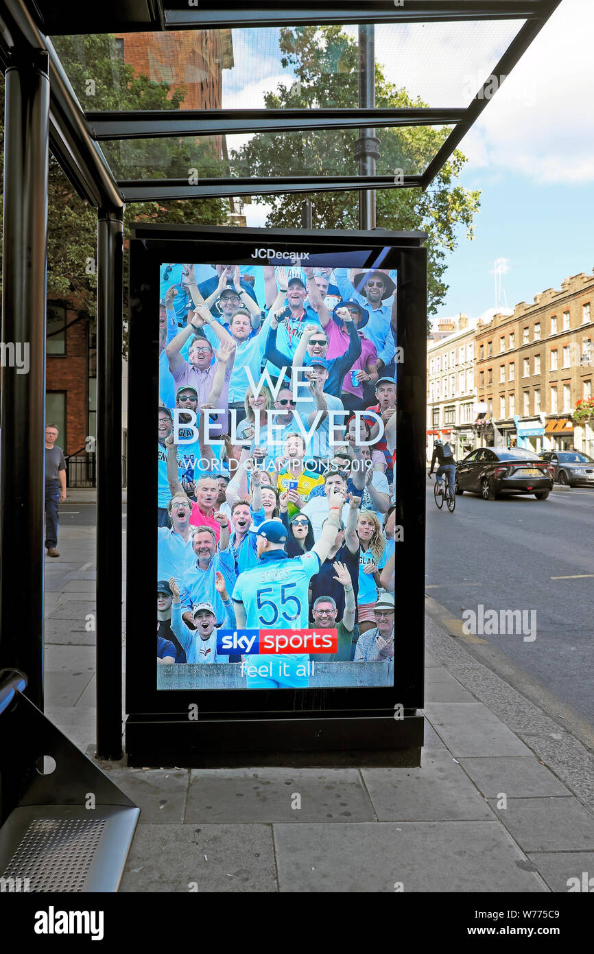 Sky Sports cricket World Cup England fans celebrating winning team 'We Believed' on a bus shelter electronic advert in a street in London KATHY DEWITT Stock Photo