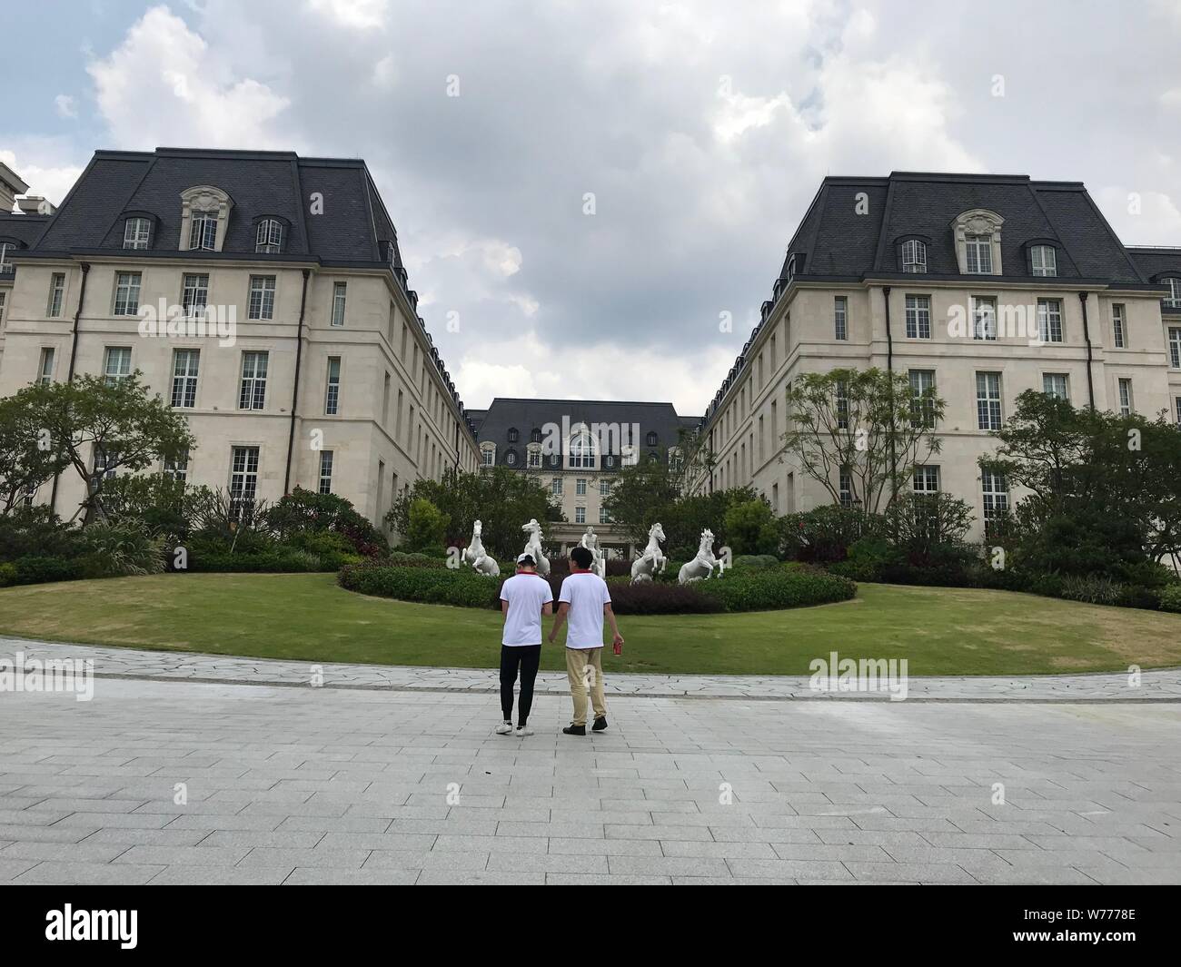 28 June 2019, China, Dongguan: People are standing in front of a replica of  the Cité