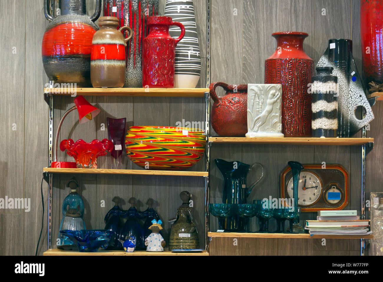 Brightly coloured mid-century modern pottery displayed on shelves in a shop in River Market, New Westminster, B. C., Canada. Stock Photo