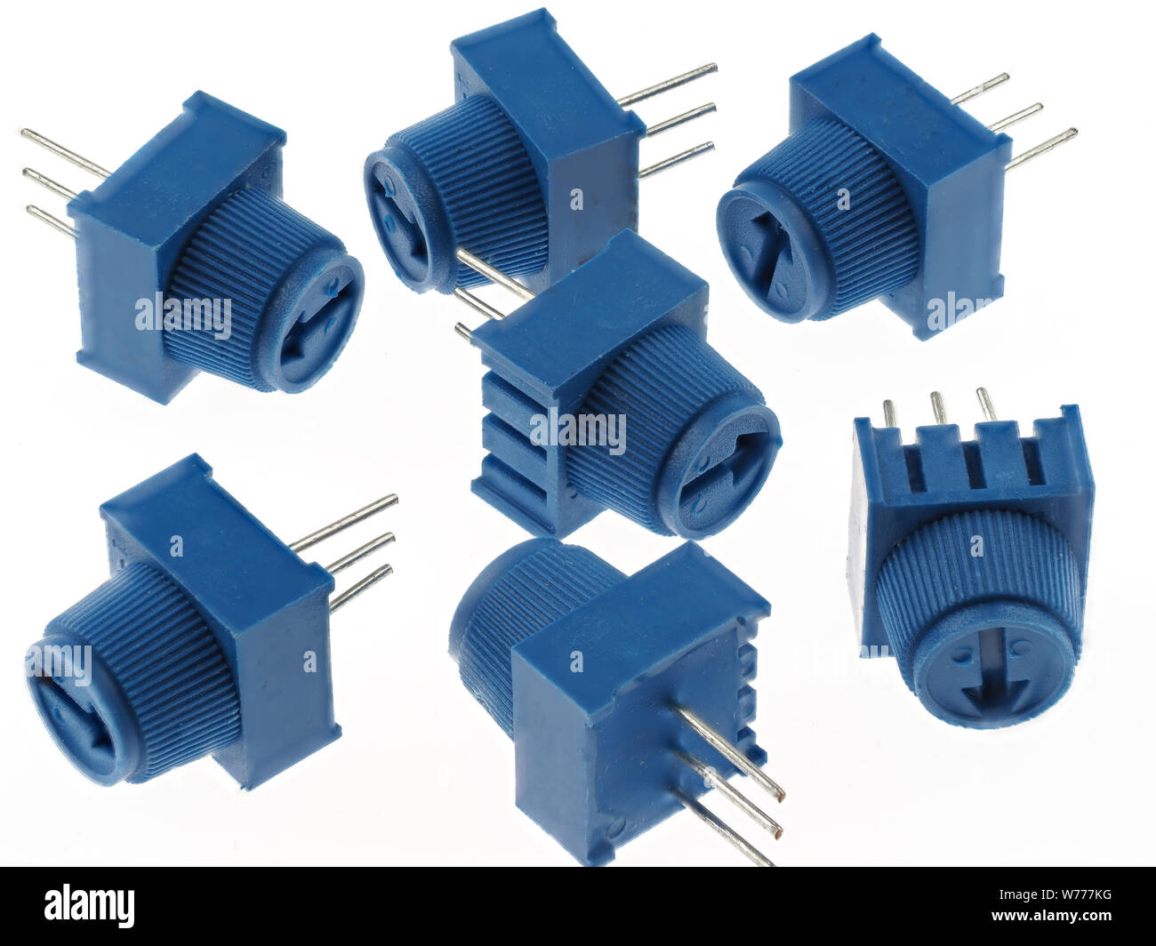 Group of blue potentiometers for PCB mounting, isolated on white. Electronics spare parts Stock