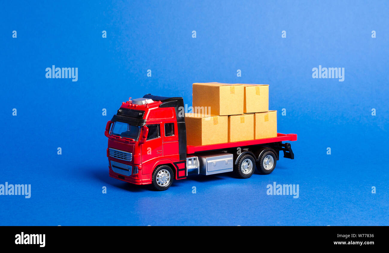 A red truck loaded with boxes. Transportation company. Services transportation of goods and products, logistics and infrastructure. Warehousing and su Stock Photo