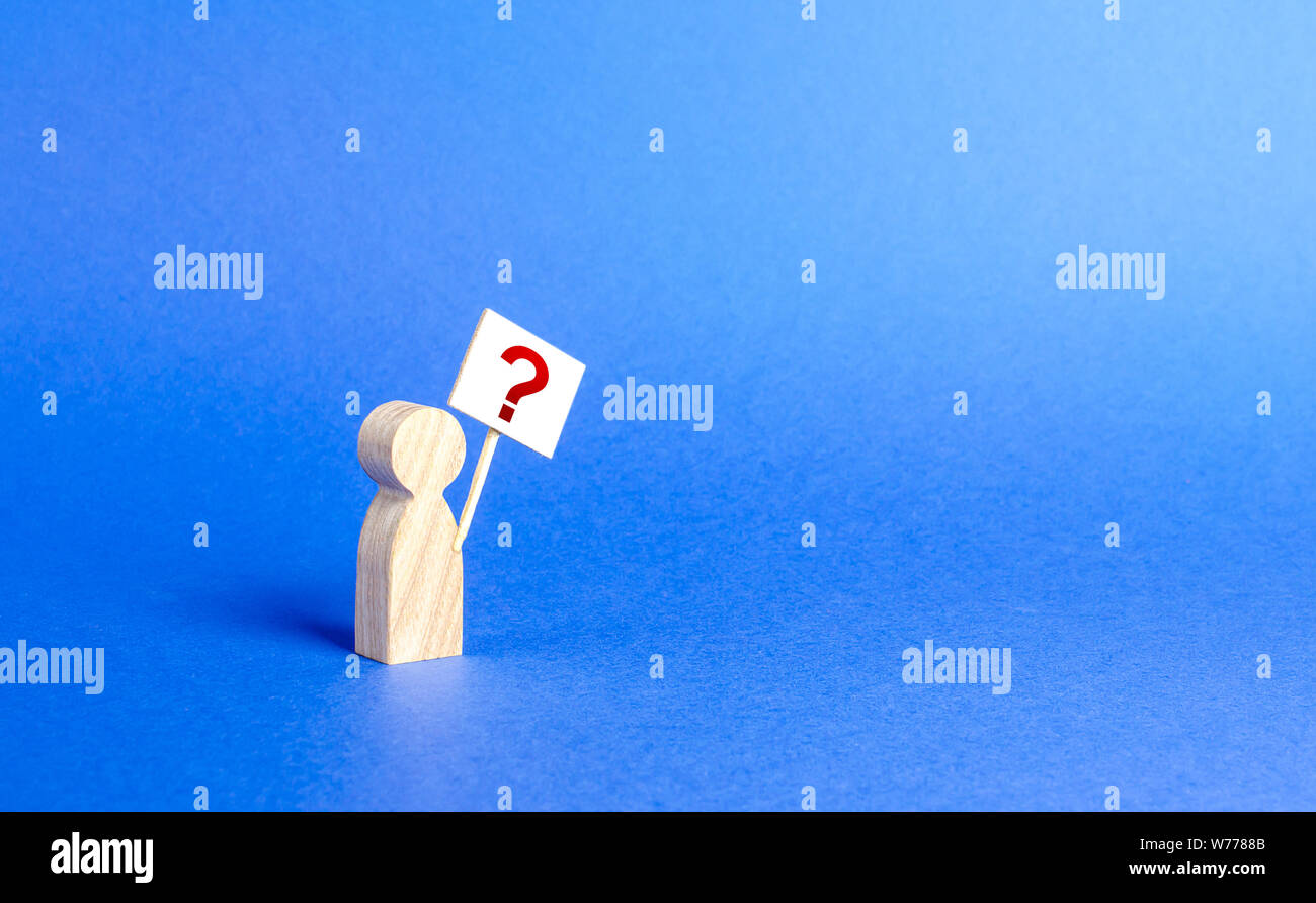 A person figurine with a question mark. Minimalism. Asking, searching for truth and demanding truth. Curiosity, desire to learn improve. Ask an uncomf Stock Photo