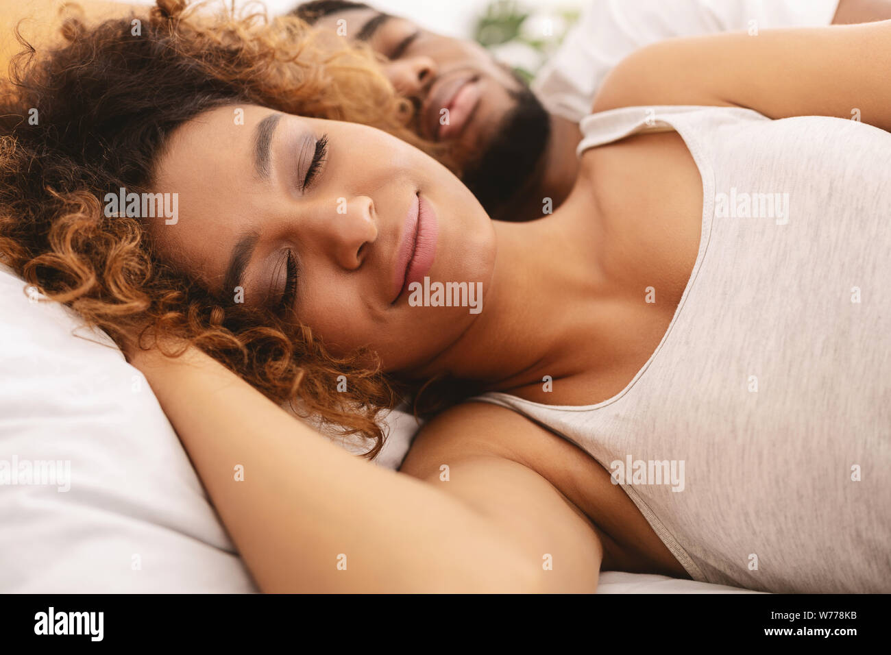 Loving couple sleeping in bed and hugging Stock Photo - Alamy