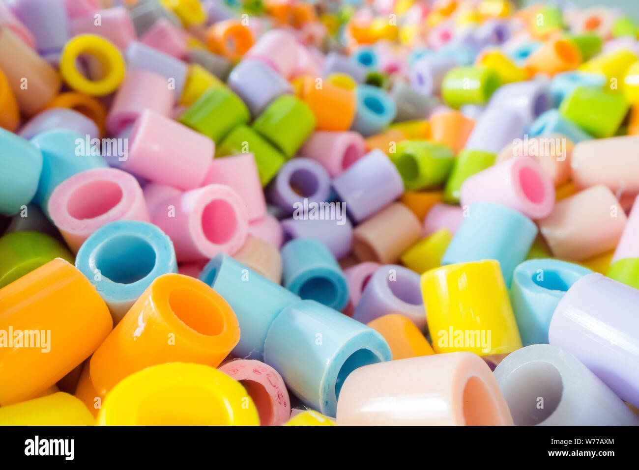 Short plastic tube pieces stacked on top of each other. Plastic waste