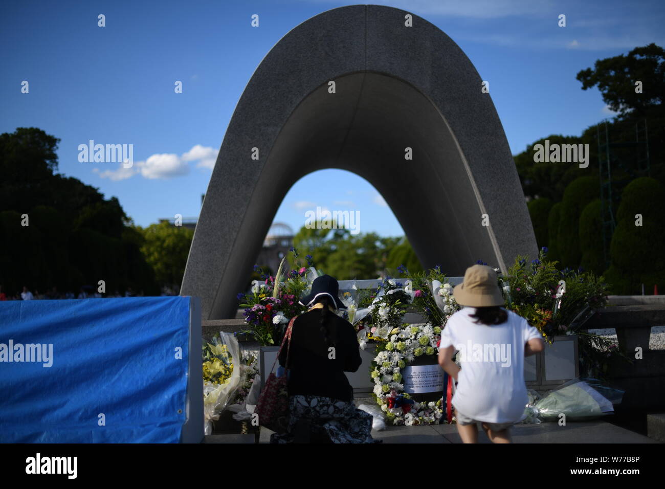 HIROSHIMA, JAPAN - AUGUST 05: Visitors lays flowers and pray for the atomic bomb victims in front of the cenotaph at the Hiroshima Peace Memorial Park in Hiroshima, western Japan on August 5, 2019, a day before the 74th anniversary ceremony of the attack. (Photo: Richard Atrero de Guzman/ AFLO) Credit: Aflo Co. Ltd./Alamy Live News Stock Photo