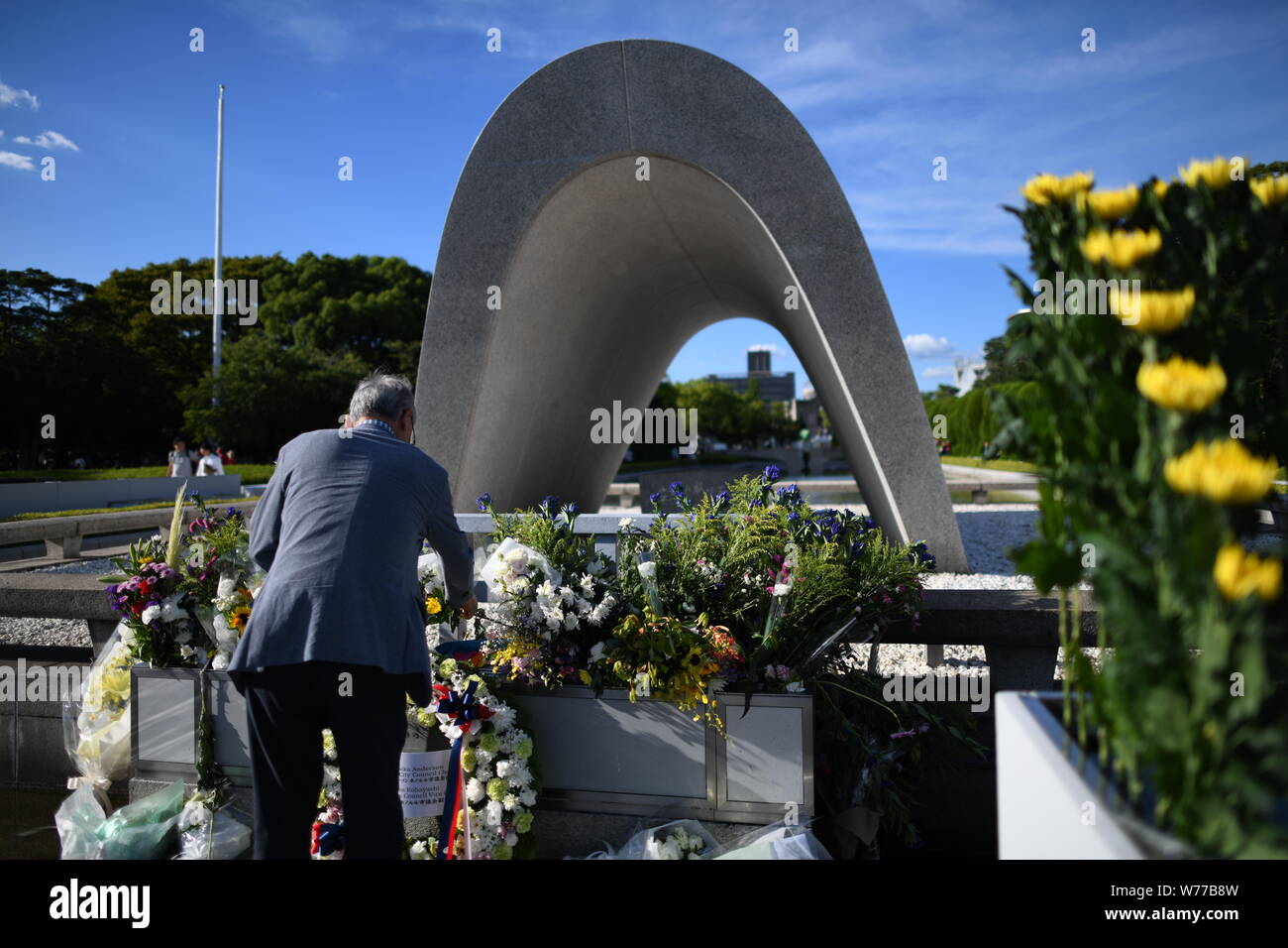 HIROSHIMA, JAPAN - AUGUST 05: A man lays flowers and pray for the atomic bomb victims in front of the cenotaph at the Hiroshima Peace Memorial Park in Hiroshima, western Japan on August 5, 2019, a day before the 74th anniversary ceremony of the attack. (Photo: Richard Atrero de Guzman/ AFLO) Credit: Aflo Co. Ltd./Alamy Live News Stock Photo