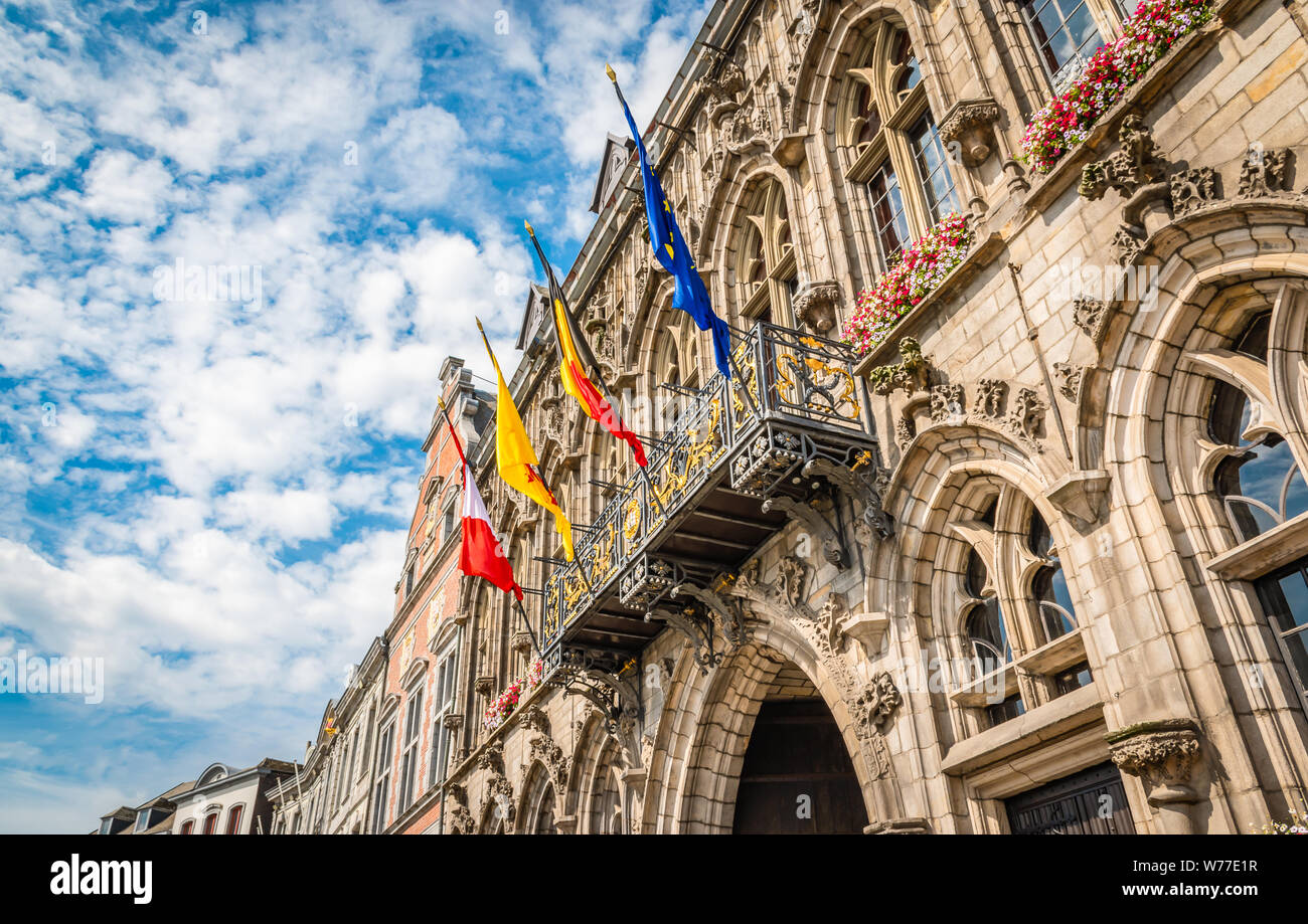 Four flags in city center of Mons, Belgium. European flag, Belgian flag, Walloon flag, Flag of Mons. Stock Photo