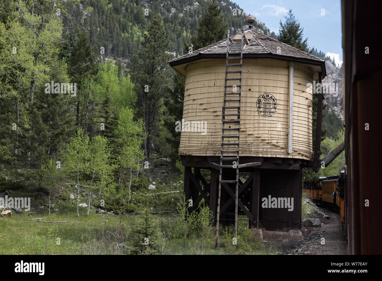 A  water tank along the route of the Durango & Silverton Narrow Gauge Railroad (D&SNG) in San Juan County, Colorado Physical description: 1 photograph : digital, tiff file, color.  Notes: The D&SNG operates 45.2 miles of track between Durango and Silverton in southwest Colorado. The route was originally opened in 1882 by the Denver & Rio Grande Railway (note that the water tank carries that line's logo) to transport silver and gold ore mined from the San Juan Mountains. The line has run continuously since 1881, and some rolling stock dates to then. It is now strictly a tourist and heritage lin Stock Photo