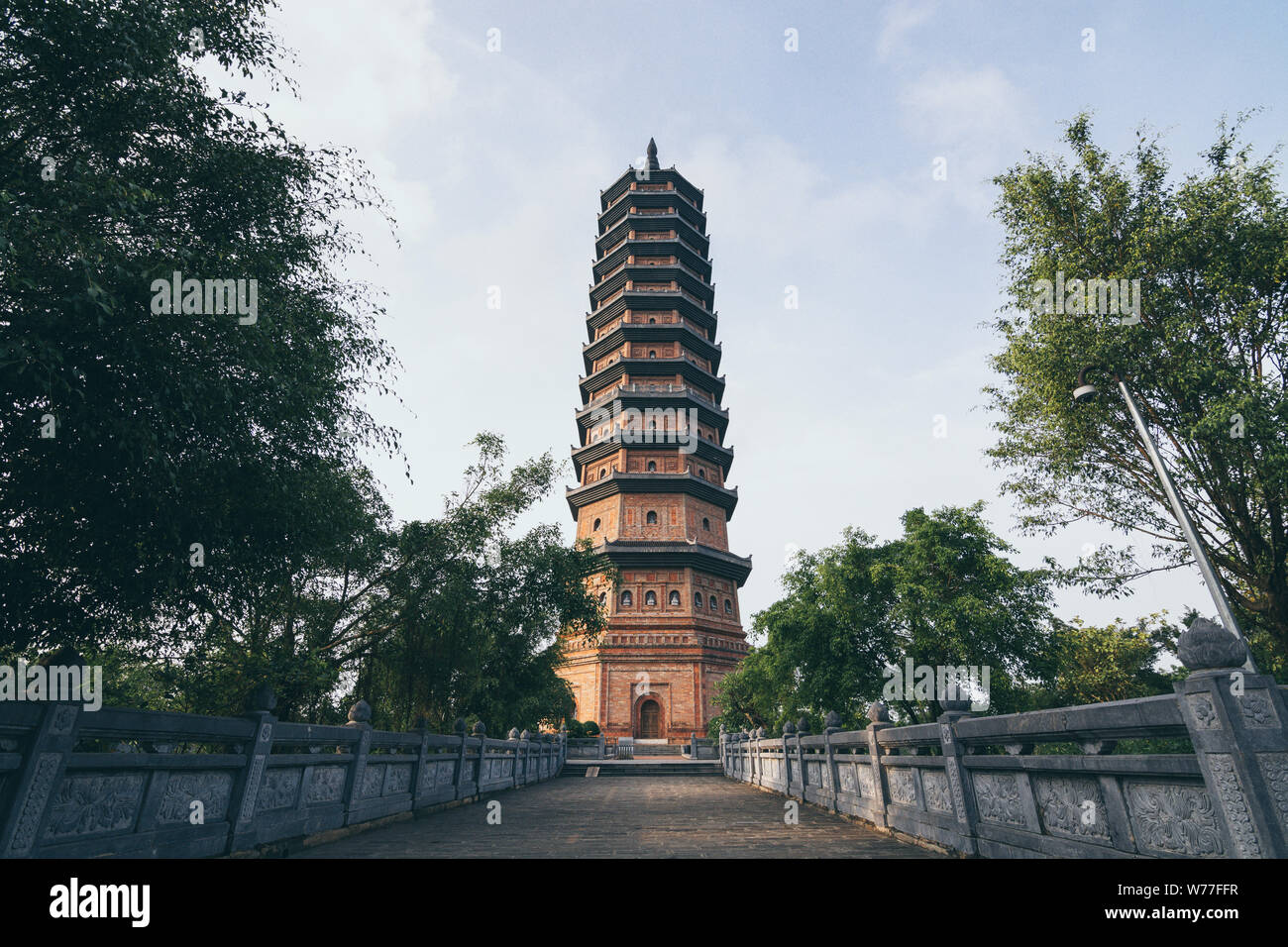 Ninh Binh, Vietnam - May 2019: sunset view over Stupa Bai Dinh Pagoda Bao Thap Tower in Buddhist temple complex. Stock Photo