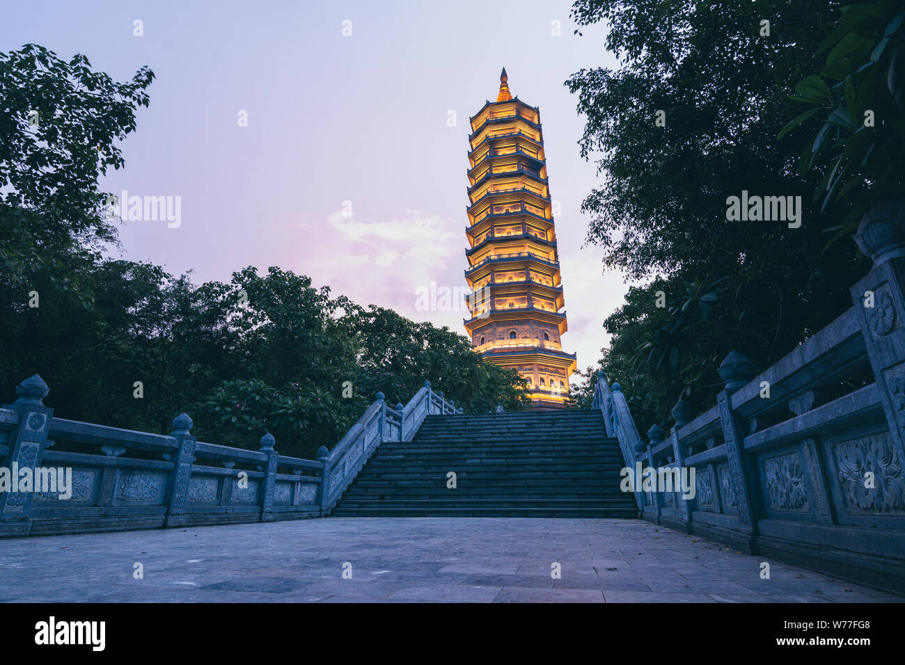 Ninh Binh, Vietnam - May 2019: sunset view over Stupa Bai Dinh Pagoda Bao Thap Tower in Buddhist temple complex. Stock Photo