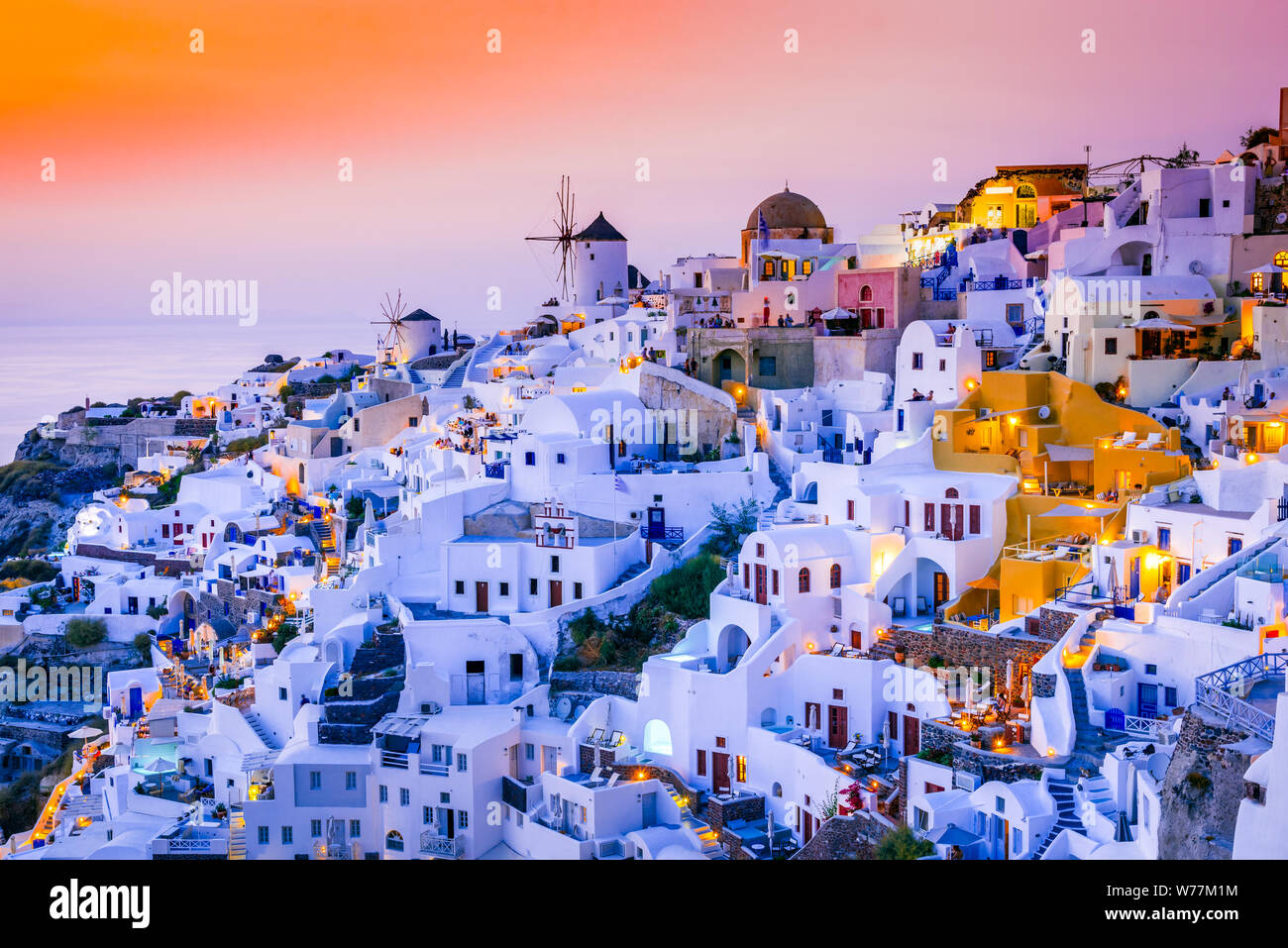 Oia, Santorini, amazing sunset wity windmills in Greek Islands, Greece. Stock Photo