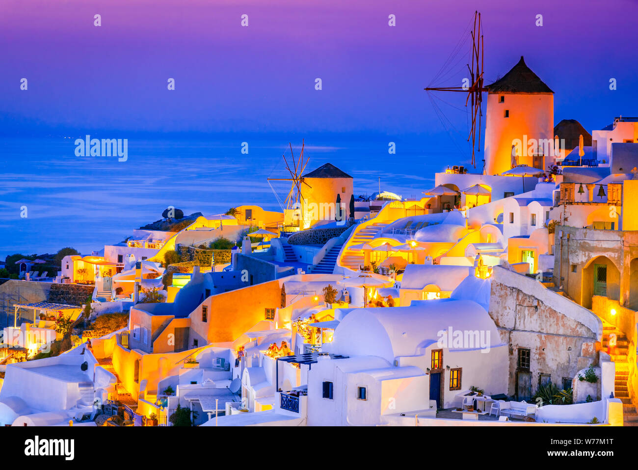 Oia, Santorini, amazing sunset wity windmills in Greek Islands, Greece. Stock Photo