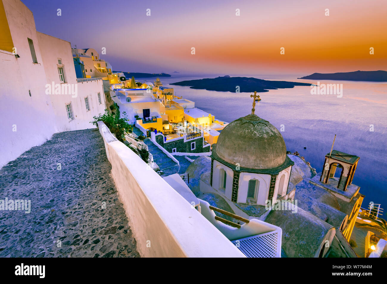 Santorini, Greece. Firostefani twilight with old greek church and caldera at Aegean Sea. Stock Photo