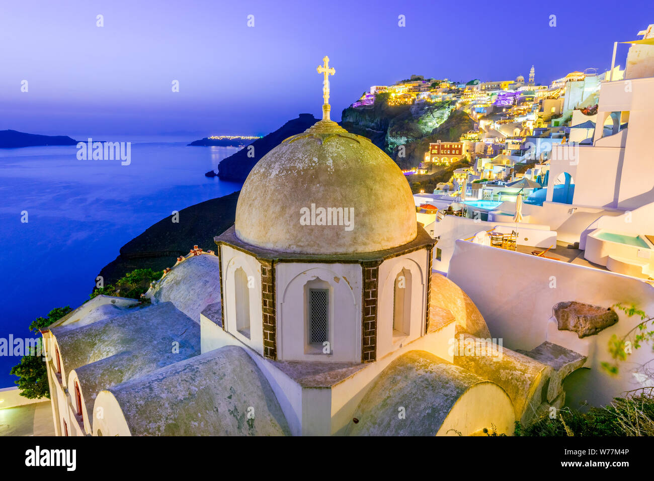 Santorini, Greece. Firostefani twilight with old greek church and caldera at Aegean Sea. Stock Photo