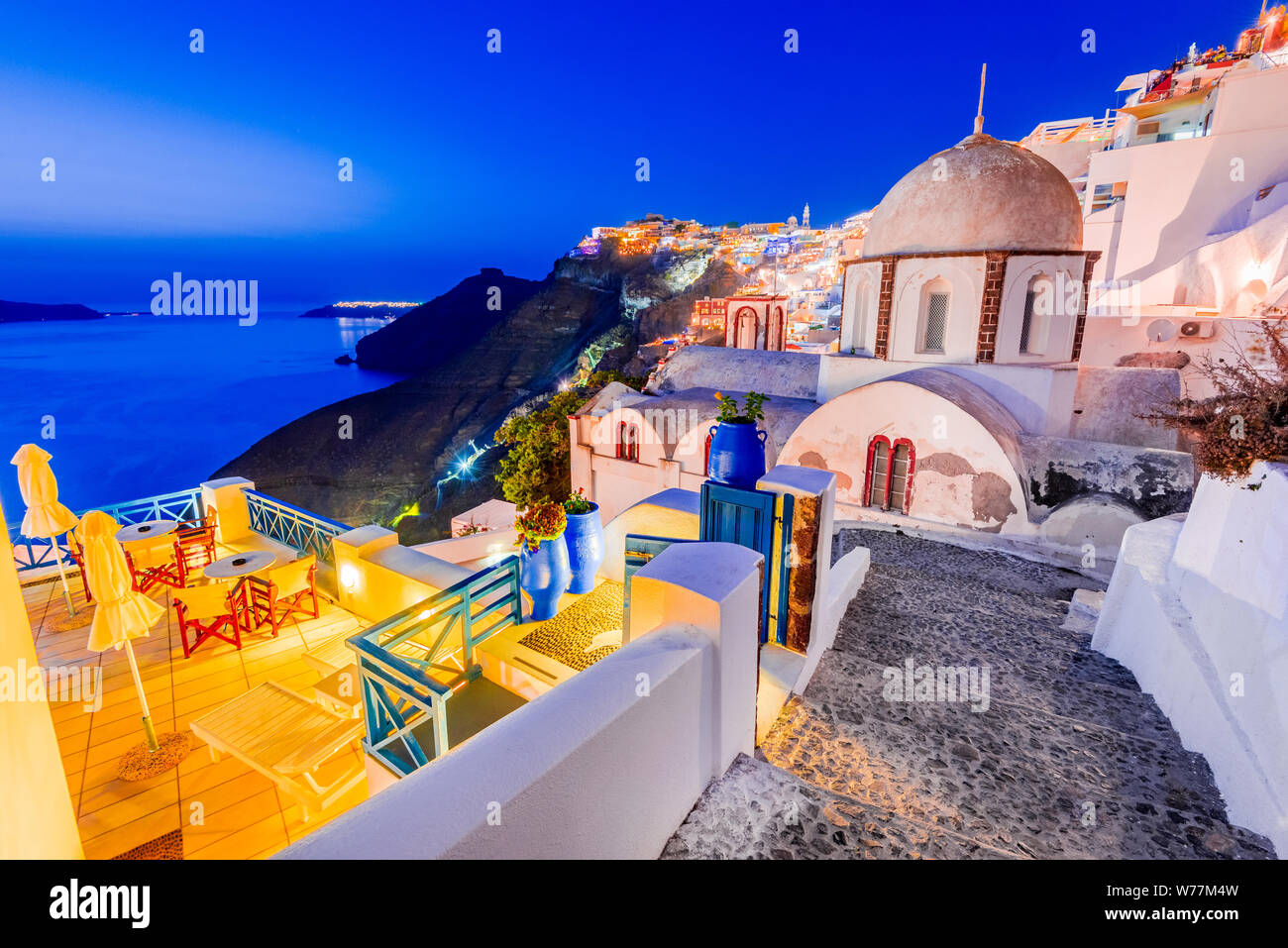 Santorini, Greece. Firostefani twilight with old greek church and caldera at Aegean Sea. Stock Photo