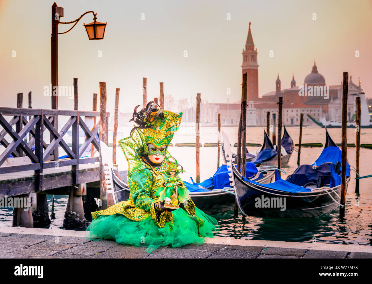 Venice, Italy, Carnival of Venice, beautiful mask at Mark's Square with St. George island in the background. Stock Photo