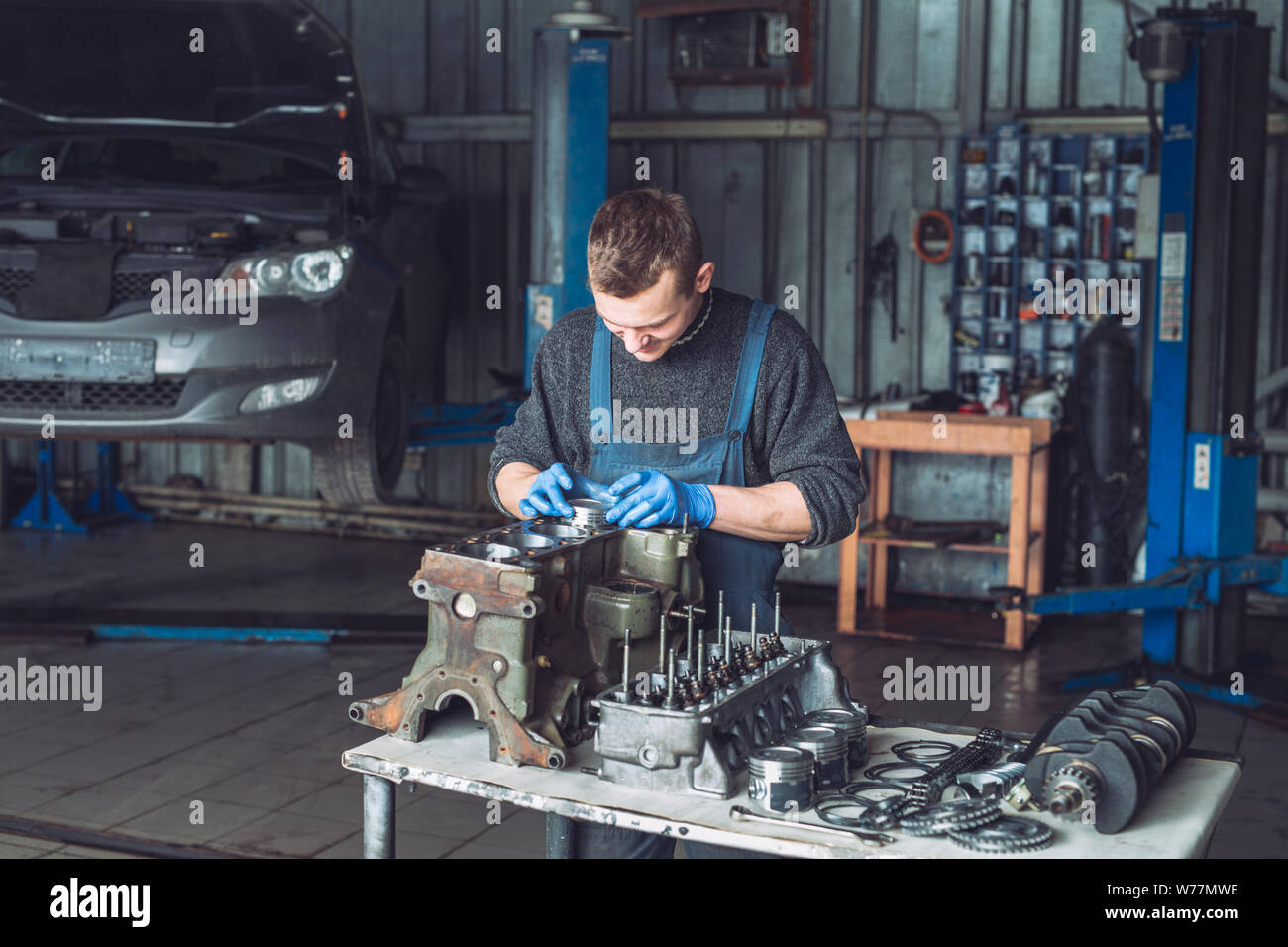 Master collects a rebuilt motor for the car Stock Photo Alamy