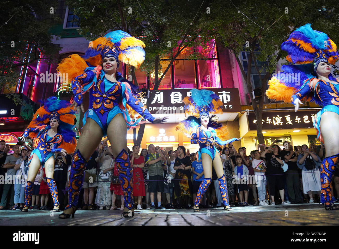 (190805) -- HARBIN, Aug. 5, 2019 (Xinhua) -- Performers are seen on the Central Avenue in Harbin, capital of northeast China's Heilongjiang Province, July 27, 2019. Attracted by the coolness in summer, many tourists come to Harbin for vacation. Meanwhile, Harbin is a city of music for the locals who got in touch with European classical music in an earlier time in China. With the cool summer and rich culture, Harbin received 36.23 million tourists and made revenue of 60.7 billion yuan (8.6 billion U.S. dollars) in the summer of 2018. (Xinhua/Wang Jianwei) Stock Photo