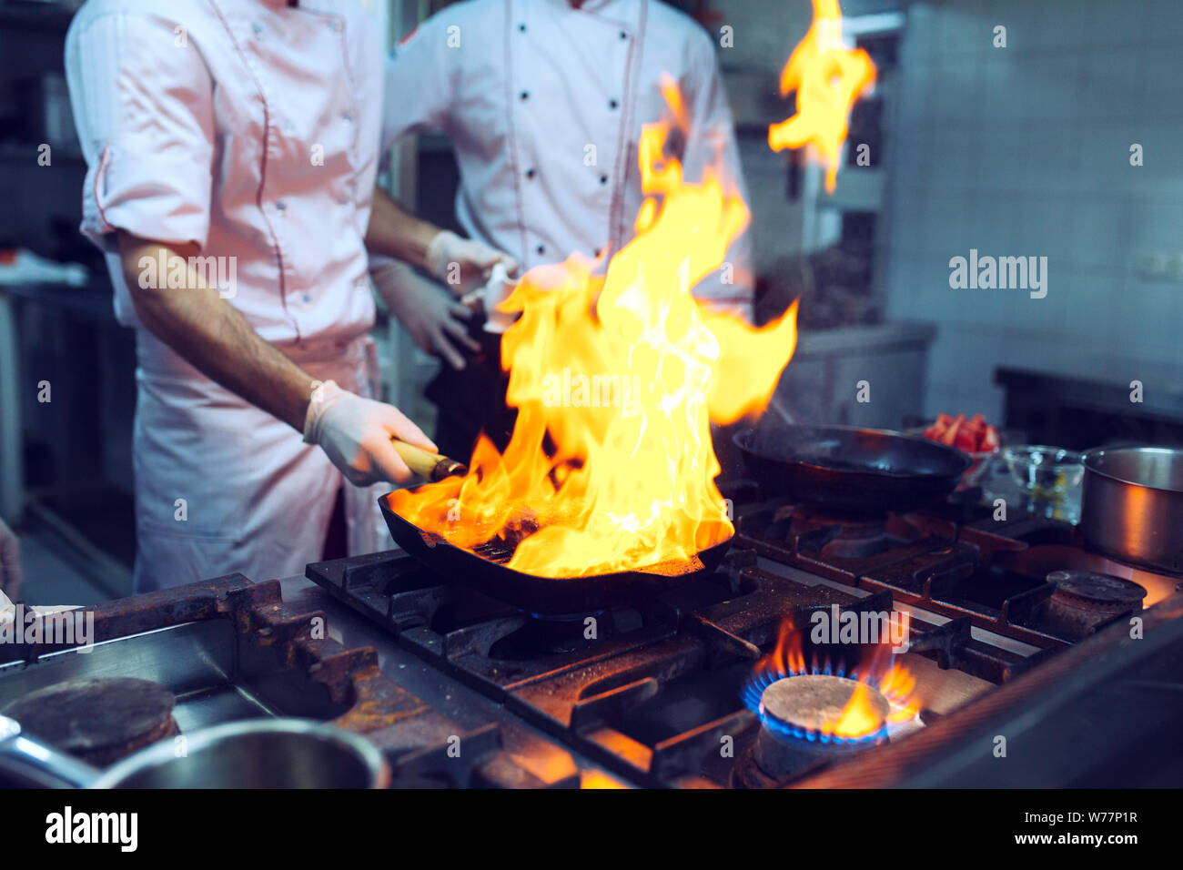 Fire in the kitchen. Fire gas burn is cooking on iron pan,stir fire ...
