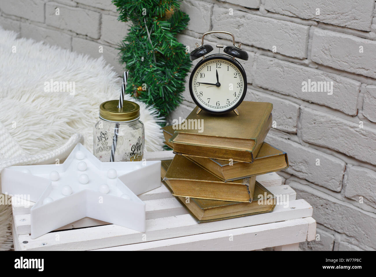 Vintage alarm clock in traditional study room showing fifteen to midnight. Happy New Year! Stock Photo