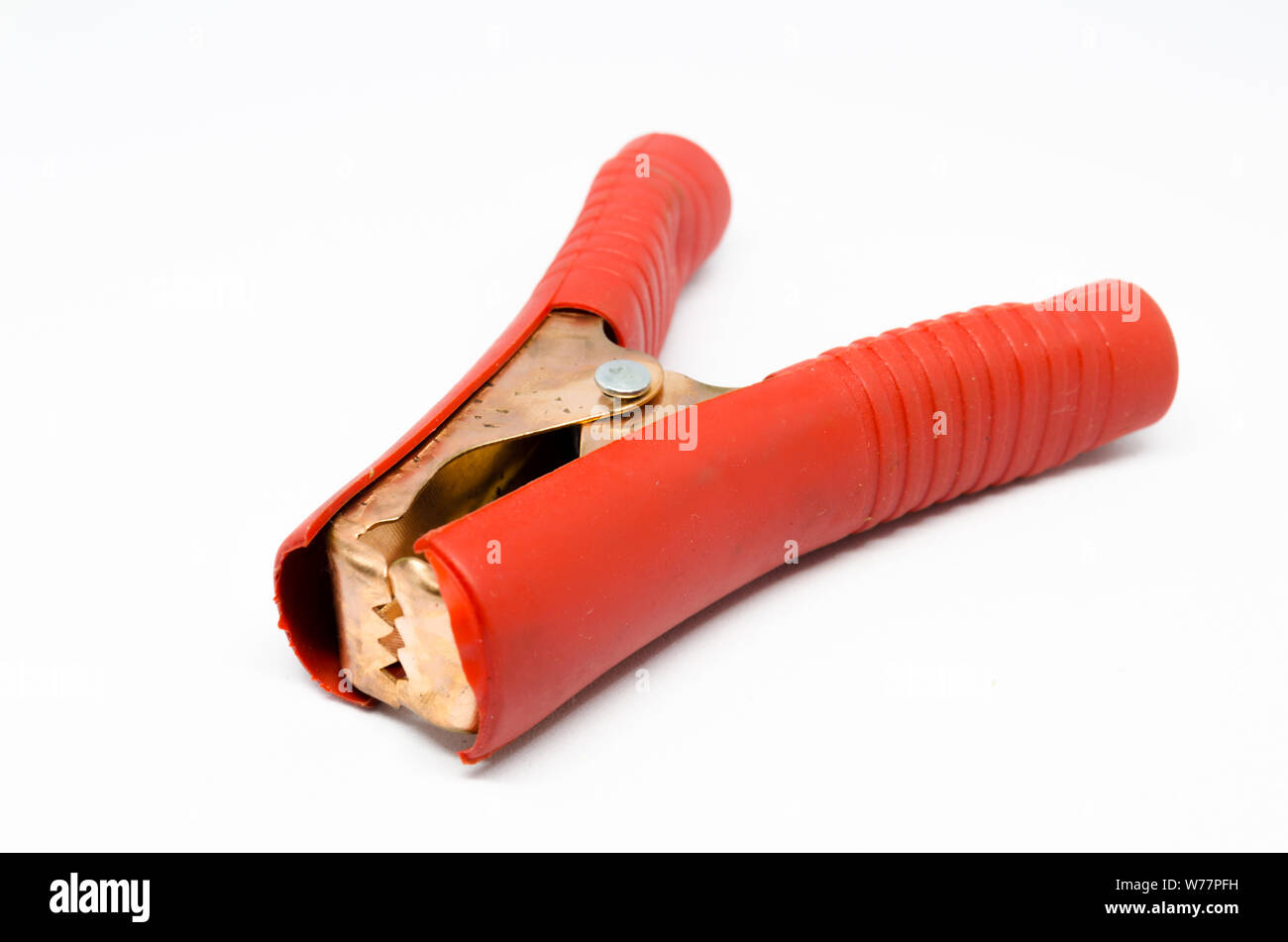 A Studio Photograph of a Red Heavy Duty Copper Crocodile Clip Stock Photo