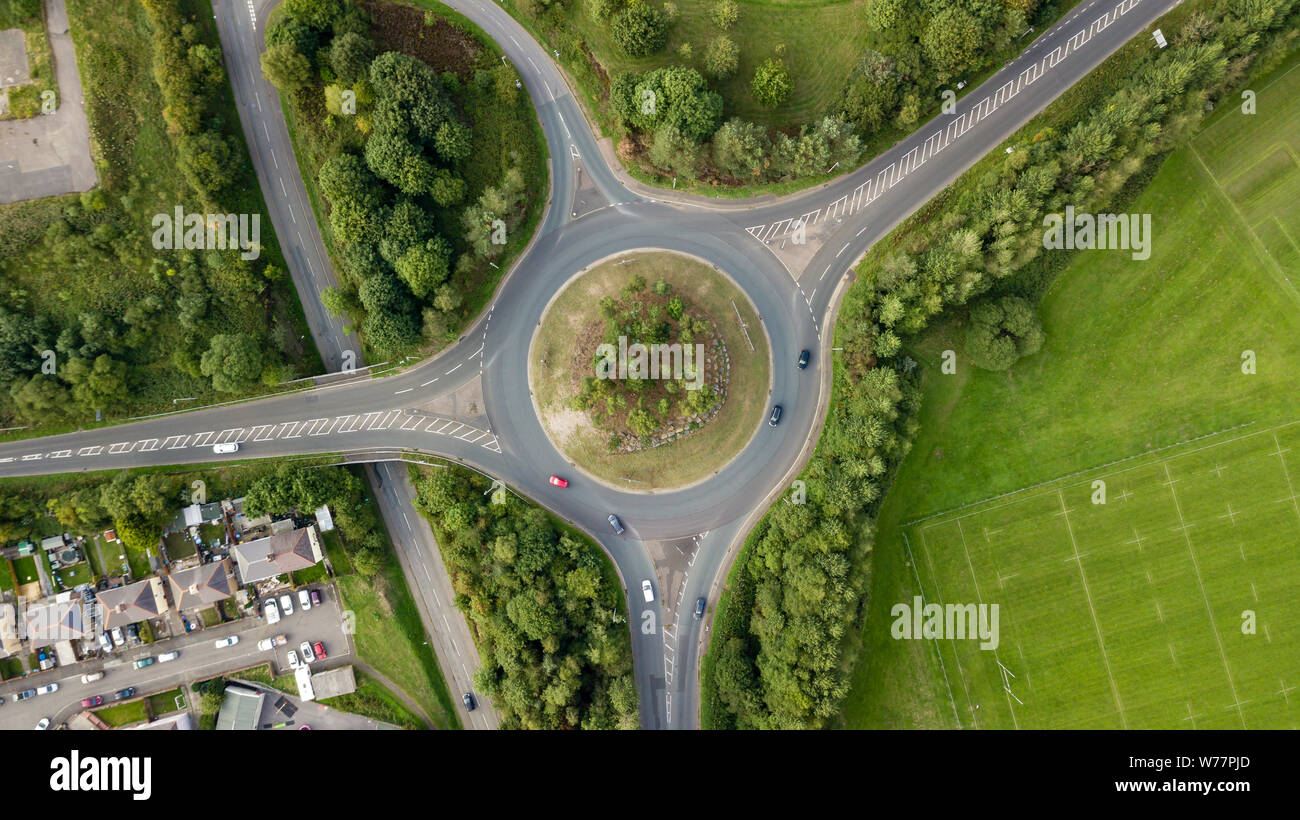 Top down aerial view of a traffic roundabout on a main road in an urban area of the UK Stock Photo