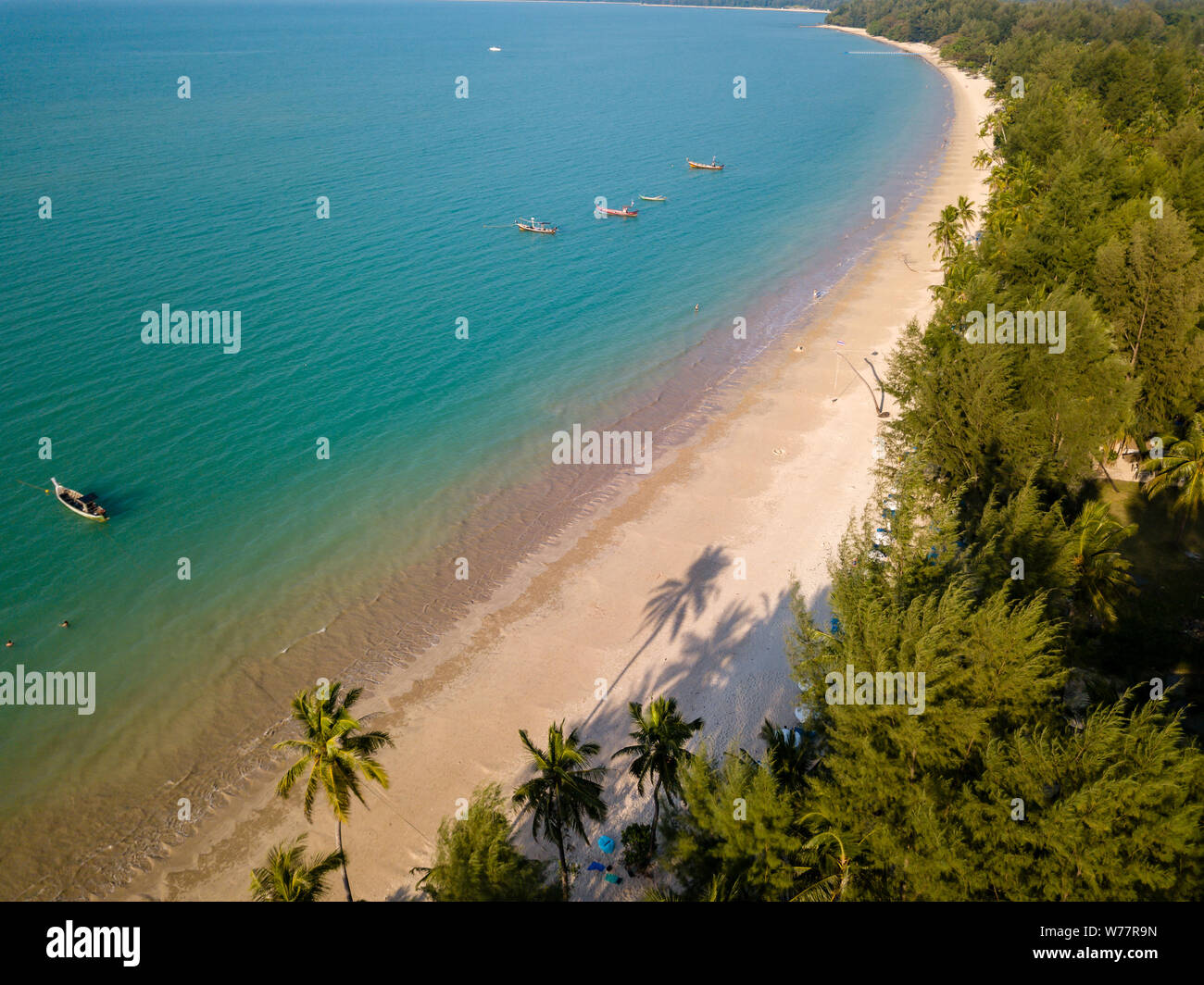 Beautiful late evening shadows on a deserted tropical beach viewed from the air Stock Photo