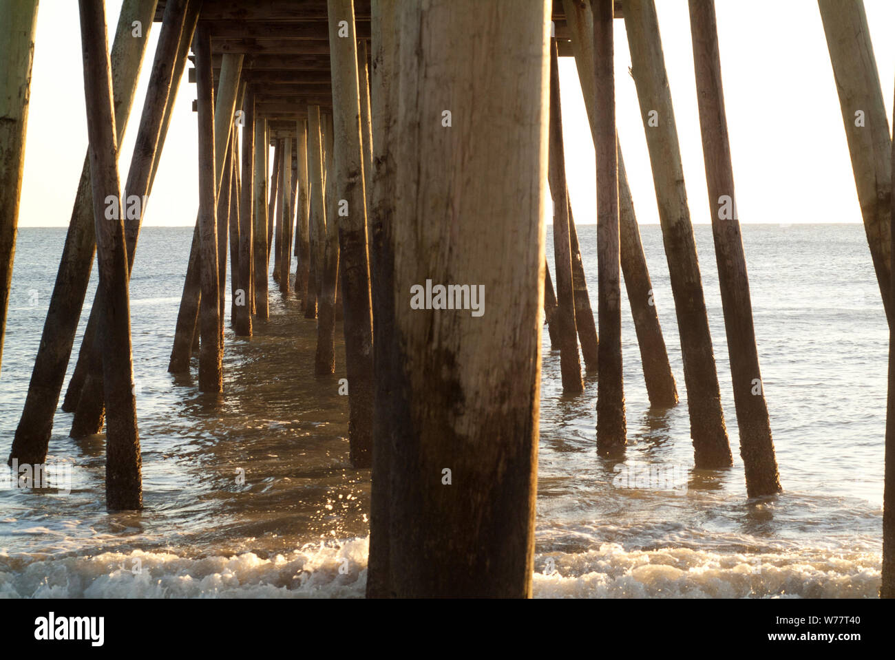 JETTY TO THE POINT: This all wooden construct stretches far out into the Atlantic ocean of Virginia beach. Stock Photo