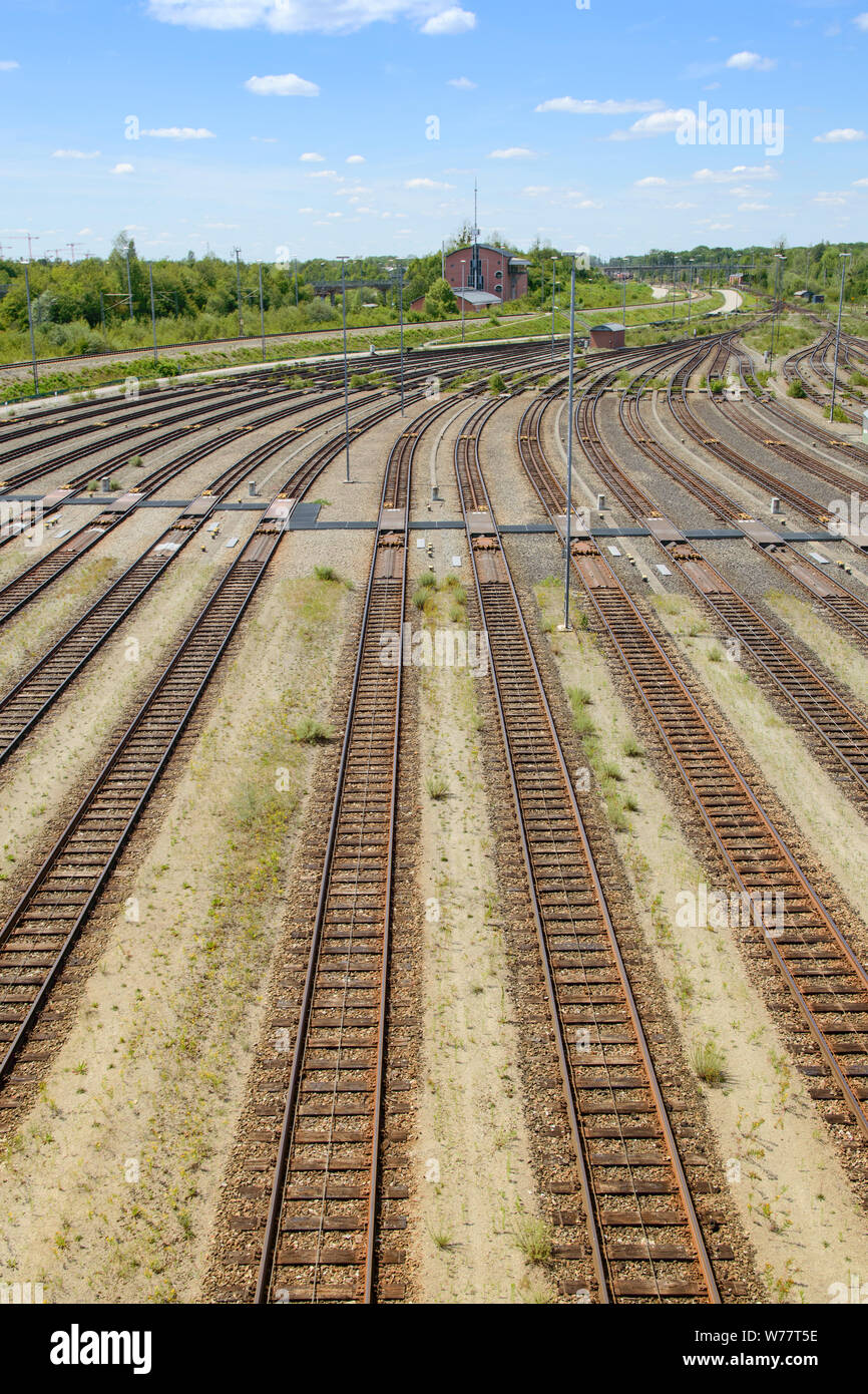 Empty freight railway classification yard with many tracks and operations control tower in the north of Munich. Vertical stock photo. Stock Photo