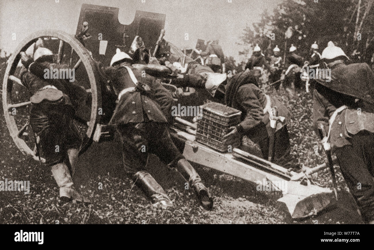 German artillery using man power to get their guns into position during WWI.  From The Pageant of the Century, published 1934. Stock Photo