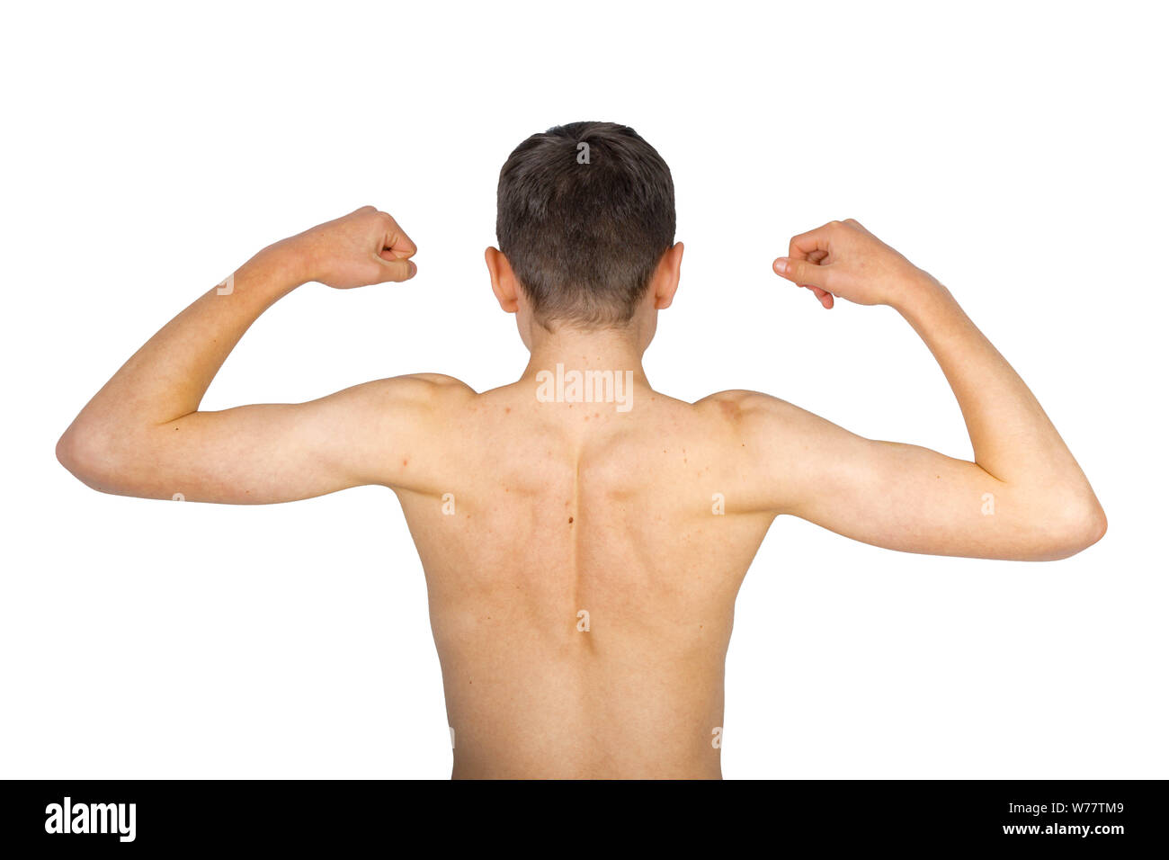 Teenage boy flexing his back muscles isolated on a white