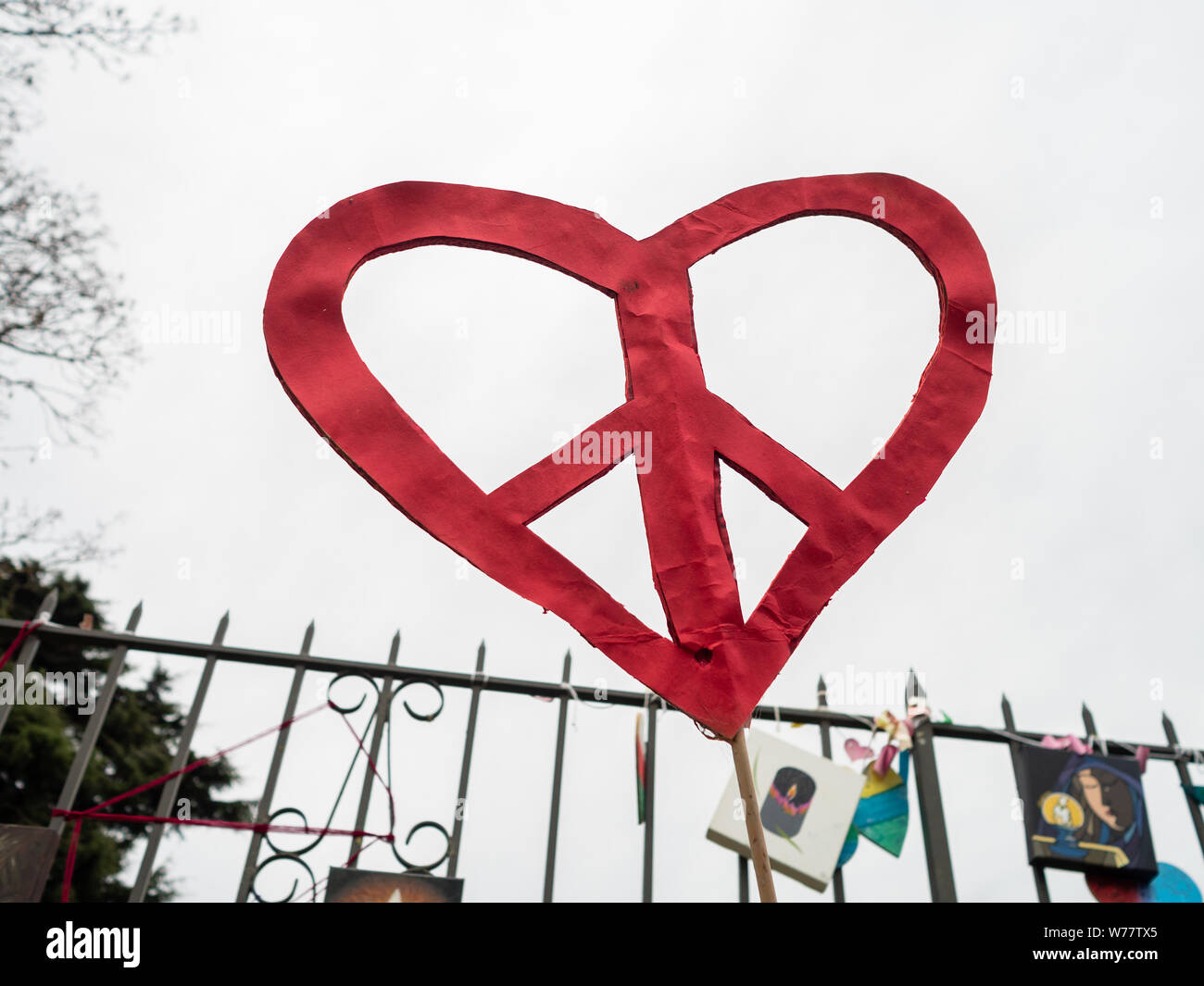 Red peace heart made from paper against a grey sky at the mosque shooting memorial in Christchurch, New Zealand Stock Photo