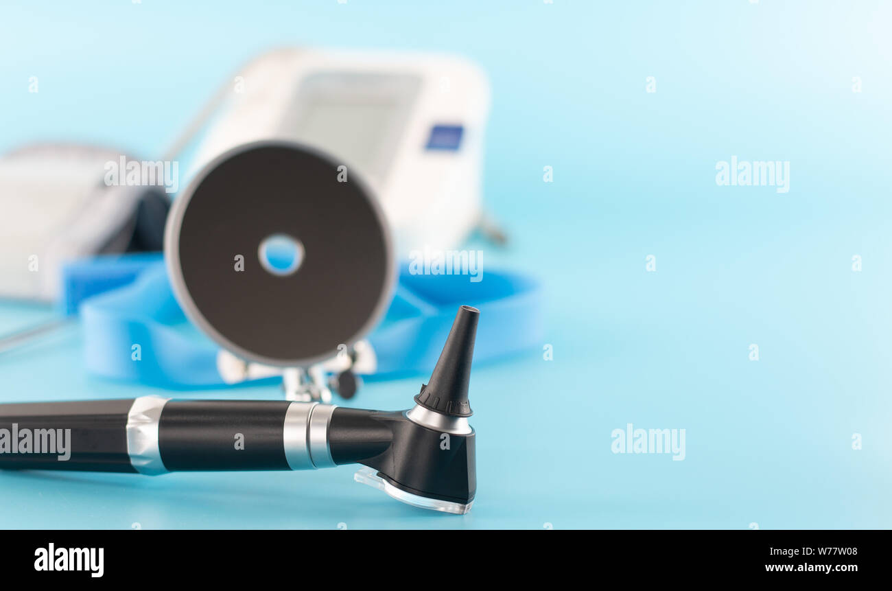 Ear professional instrument on blue background Stock Photo - Alamy