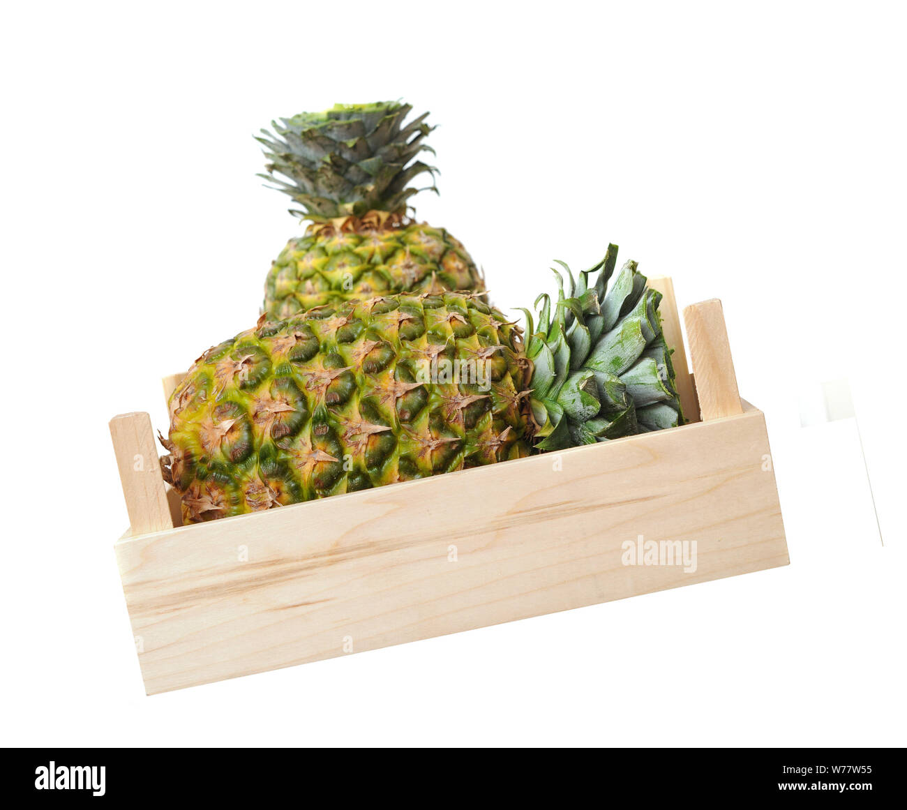 two pineapples in crate isolated on white background Stock Photo